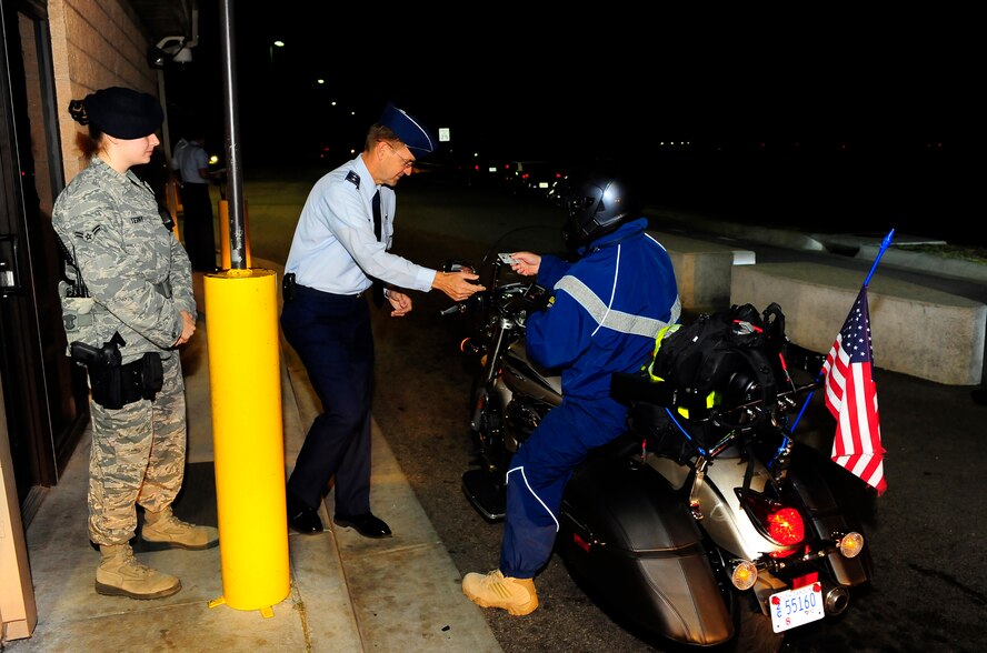 U.S. Air Force Maj. Gen. Stephen Hoog, 9th Air Force commander, and Airman 1st Class Terry Challen, 20th Security Forces Squadron, check identification cards at the main gate on Shaw Air Force Base, S.C. Sept. 19, 2011. Hoog took a tour around Shaw to see and thank team members of the base for their hard work and dedication.  (U.S. Air Force photo/Airman 1st Class Neil D. Warner) (Released)