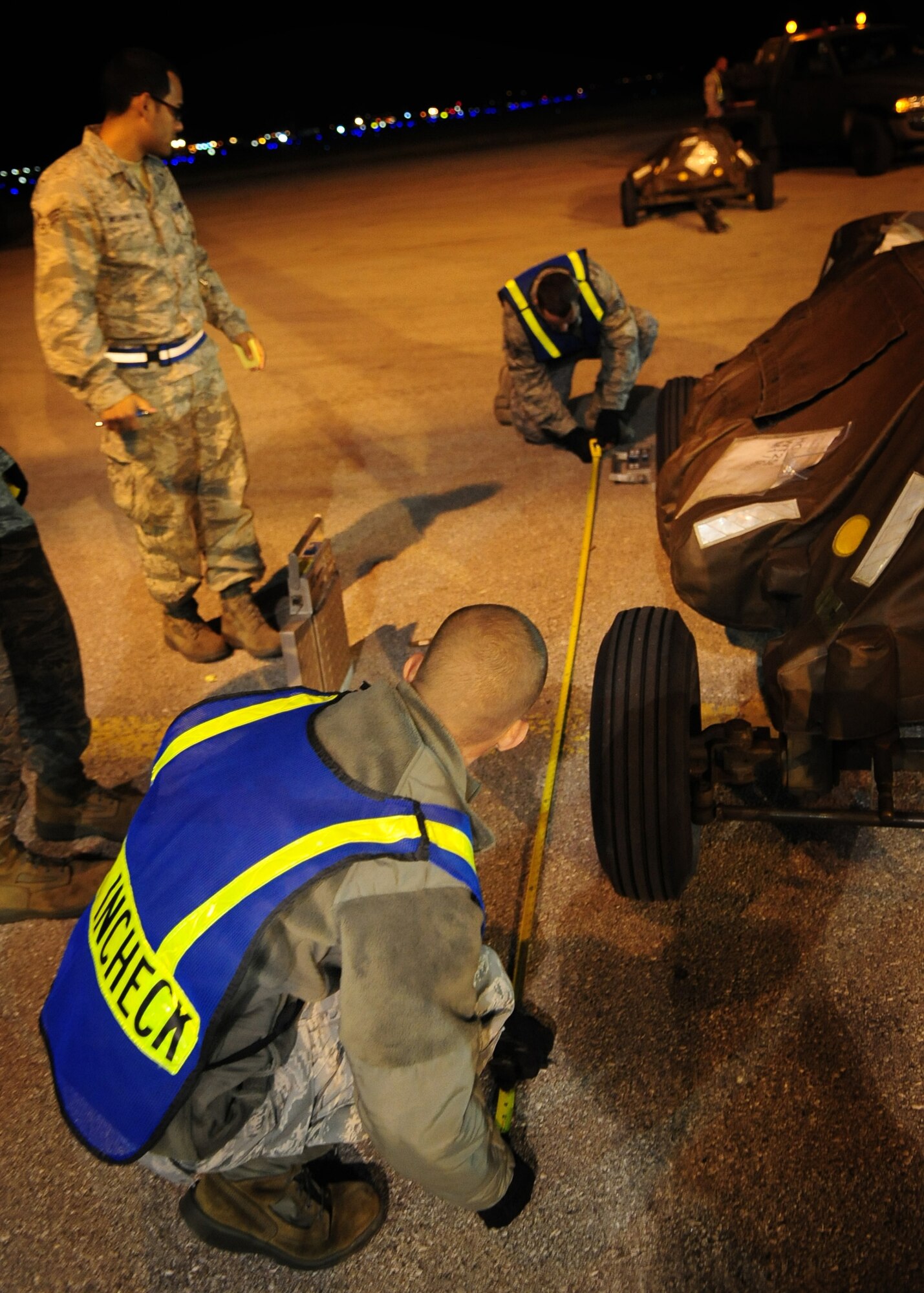 Airmen measure cargo during the In-Checking process as part of an Operational  Sept. 21 at Aviano Air Base, Italy.  Aviano Airmen are participating in an Operational Readiness Exercise, a training tool that ensures Airmen are ready to deploy and work in deployed locations. (U.S. Air Force Photo/ Senior Airman Evelyn Chavez)