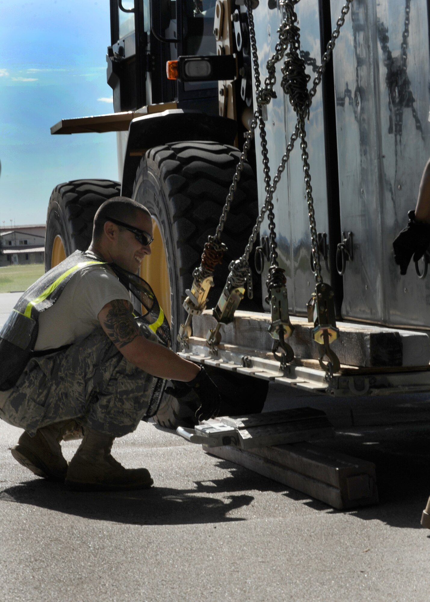 Senior Airman Jakob Alonzo, 31st Logistics Readiness Squadron, vehicle maintenance technician guides a cargo pallet down to a weight scale during an operational readiness exercise Sept. 20 at Aviano Air Base, Italy. As a cargo deployment function team member, Alonzo is responsible for the in processing and shipping all 31st Fighter Wing cargo requirements. (U.S. Air Force photo/ Staff Sgt. Nadine Y. Barclay)