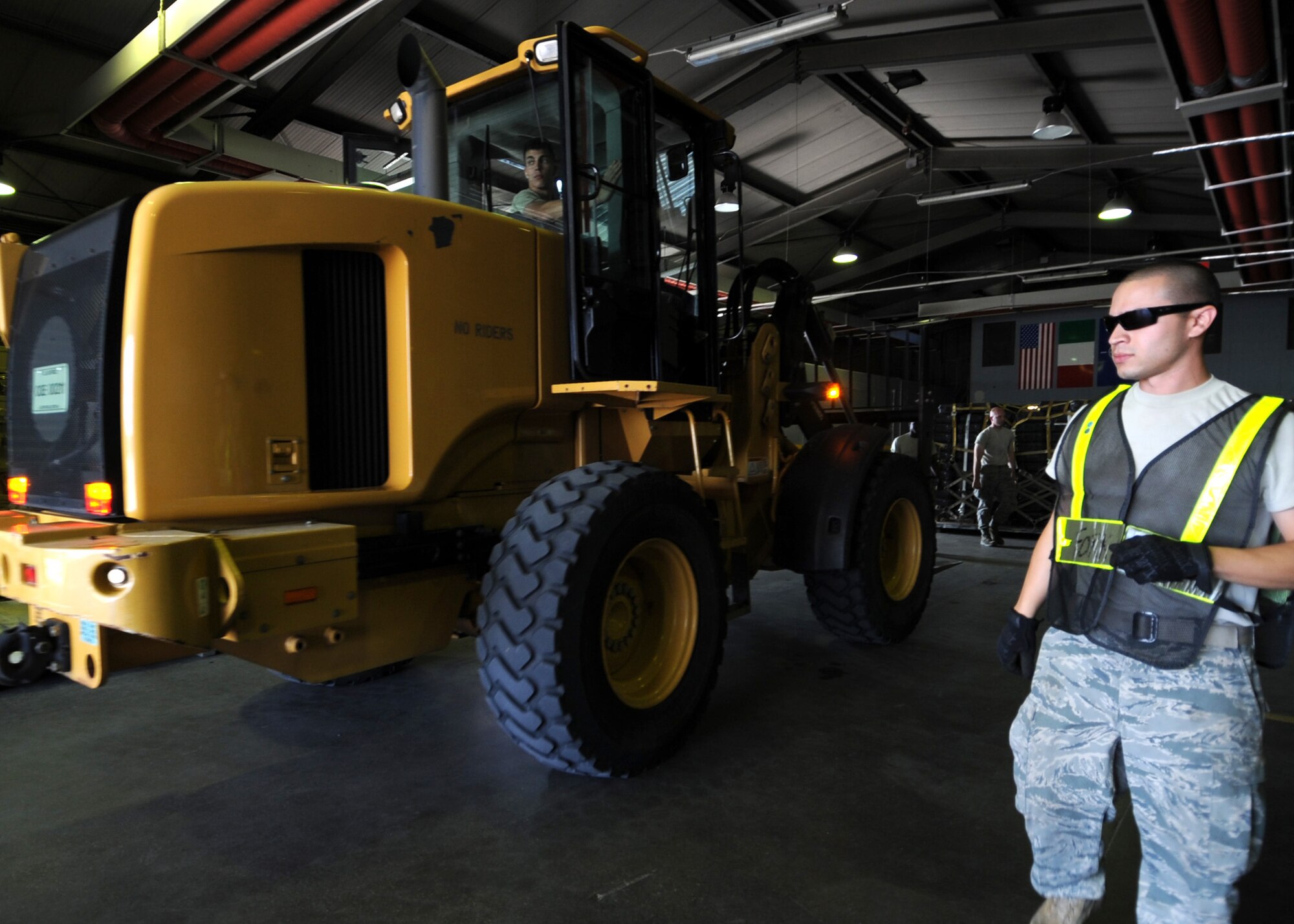 Senior Airman Jakob Alonzo, 31st Logistics Readiness Squadron, vehicle maintenance technician guides a forklift carrying cargo pallets during an operational readiness exercise Sept. 20 at Aviano Air Base, Italy. As a cargo deployment function team member, Alonzo is responsible for the in processing and shipping all 31st Fighter Wing cargo requirements. (U.S. Air Force photo/ Staff Sgt. Nadine Y. Barclay)