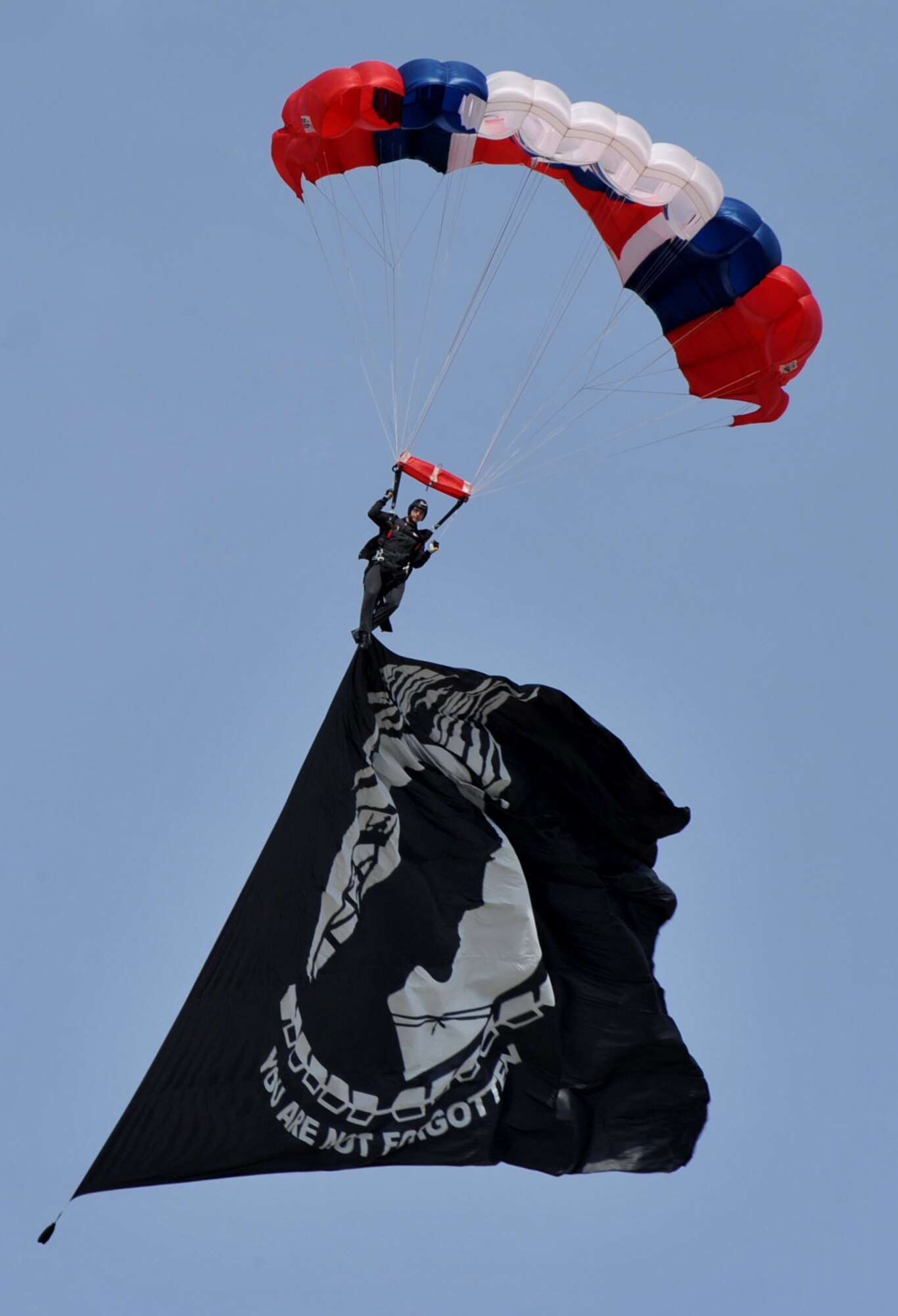 MOUNTAIN HOME AIR FORCE BASE, Idaho – An 82nd Airborne member flies the Prisoner of War flag to begin Gunfighter Skies 2011 here Sept 17. The 82nd Airborne Division strategically deploys and conducts forcible entry parachute assaults to secure key objectives for military operations in support of U.S. interests. (U.S. Air Force photo by Airman 1st Class Heather Hayward) 