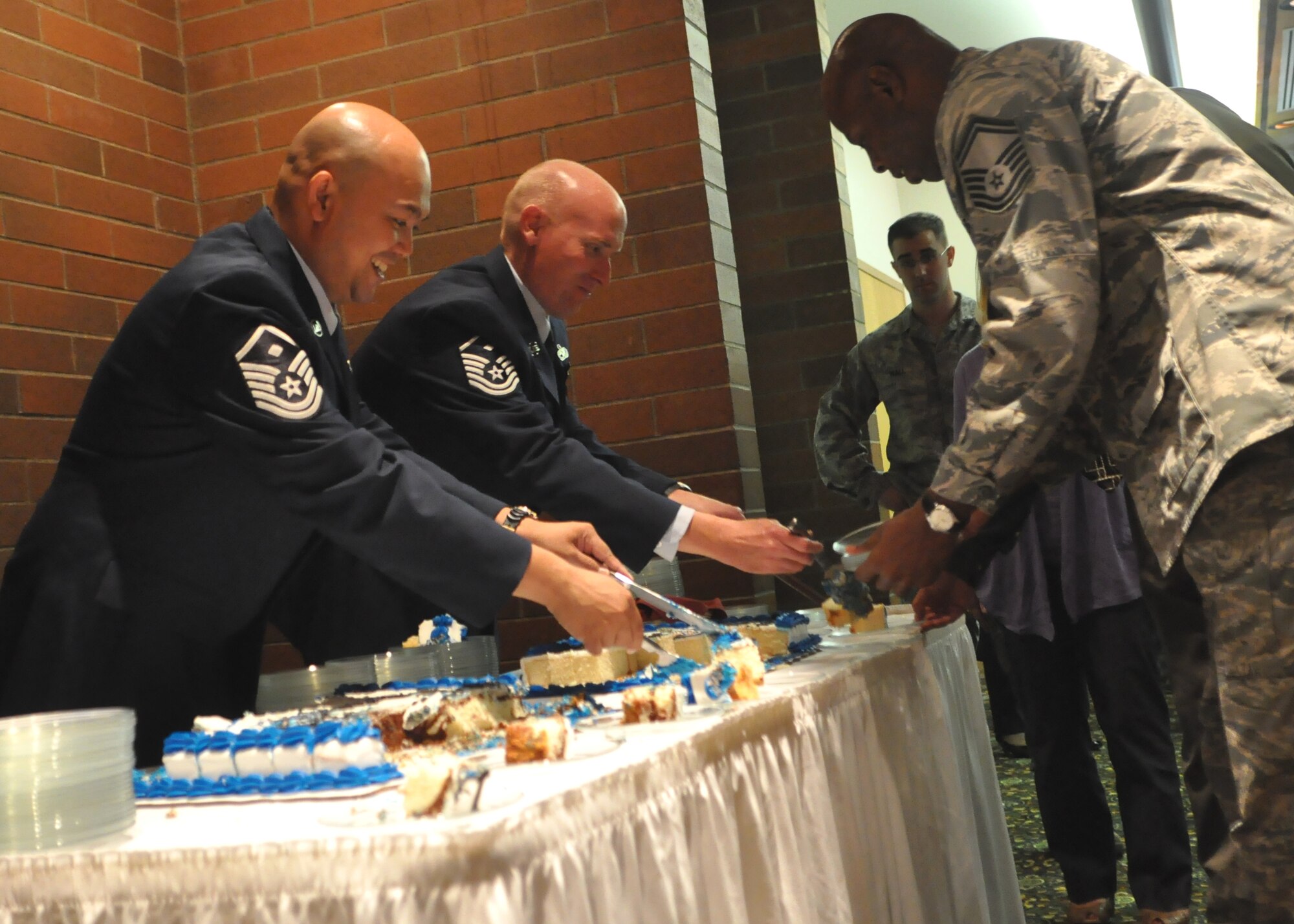 First sergeants serve cake to guests during the Prisoner of War/Missing in Action Recognition Day luncheon at the McChord Field Club Sept. 16, 2011, at Joint Base Lewis-McChord, Wash. (U.S. Air Force photo/Airman 1st Class Leah Young)