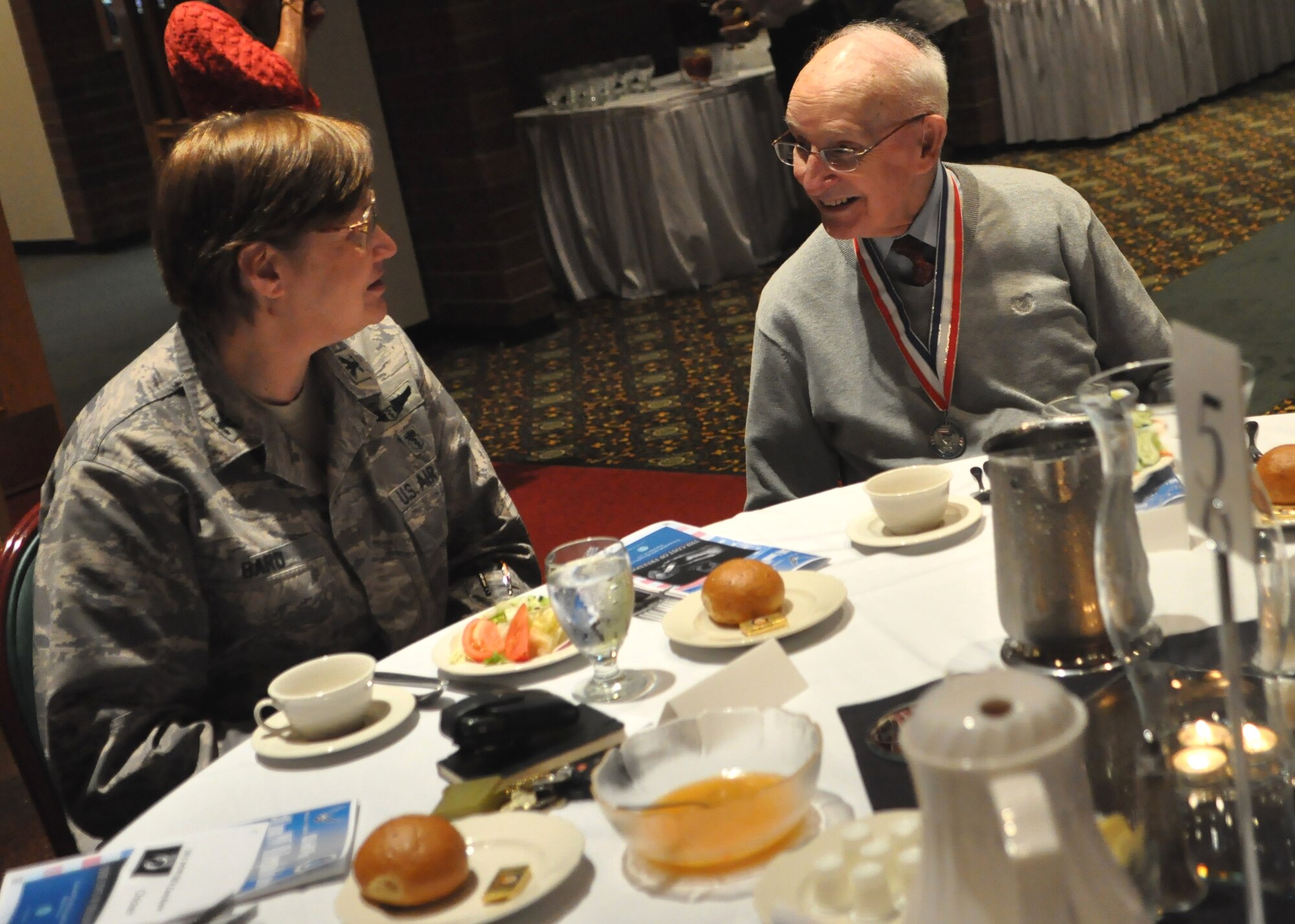Col. Catherine Bard, left, 62nd Medical Squadron commander, speaks with a former prisoner of war during the Prisoner of War/Missing in Action Recognition Day luncheon at the McChord Field Club Sept. 16, 2011, at Joint Base Lewis-McChord, Wash. (U.S. Air Force photo/Airman 1st Class Leah Young)