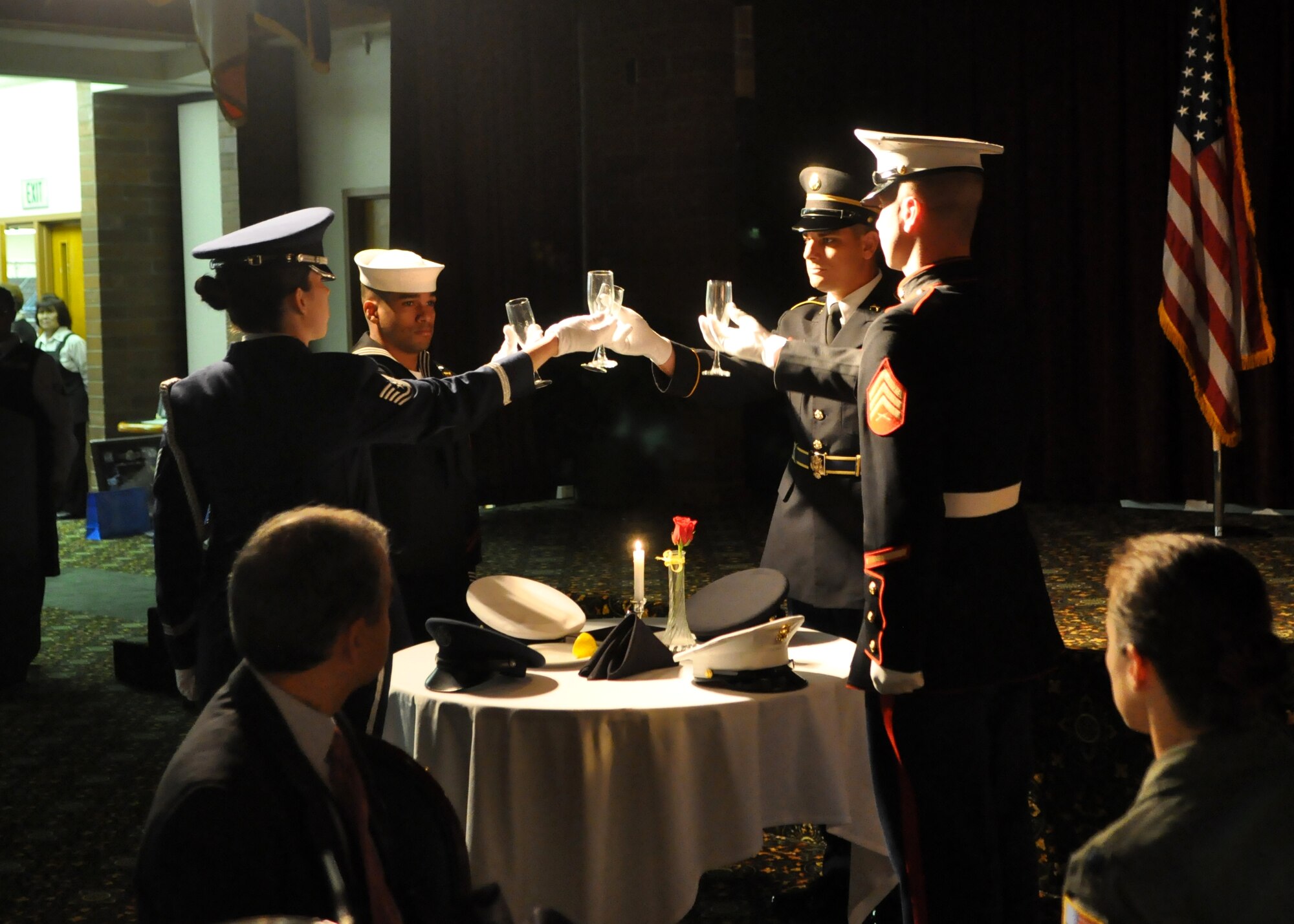 Representatives from each branch of the military raise a glass above the “Missing Man Table” to honor the service members missing in action during the Prisoner of War/Missing in Action Recognition Day luncheon at the McChord Field Club Sept. 16, 2011, at Joint Base Lewis-McChord, Wash. (U.S. Air Force photo/Airman 1st Class Leah Young)