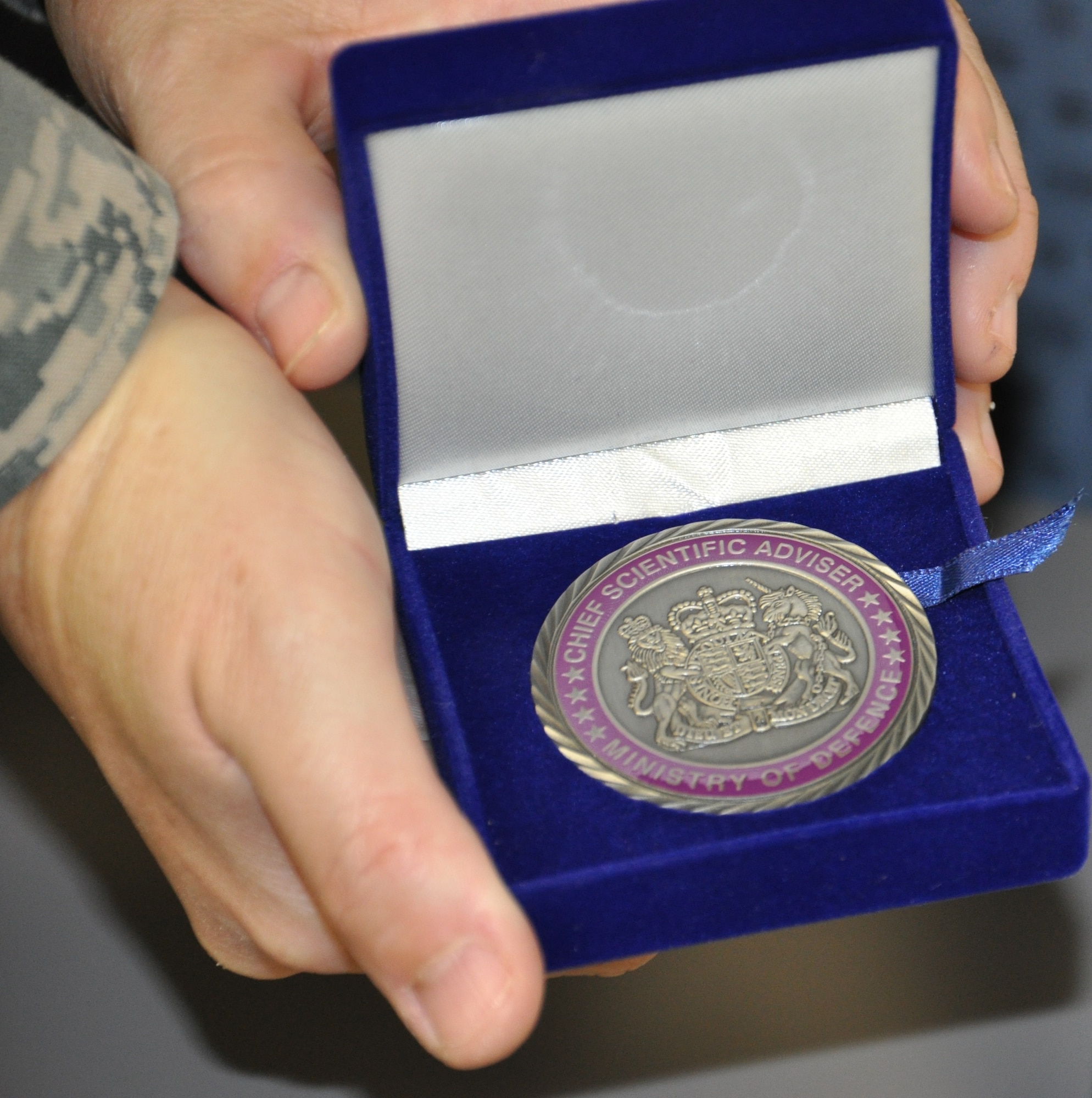 The Special Commendation Coin from the United Kingdom's Defence Science and Technology Laboratory is one of the highest honors bestowed upon Ministry of Defence researchers. (U.S. Air Force photo Chandra Lloyd)