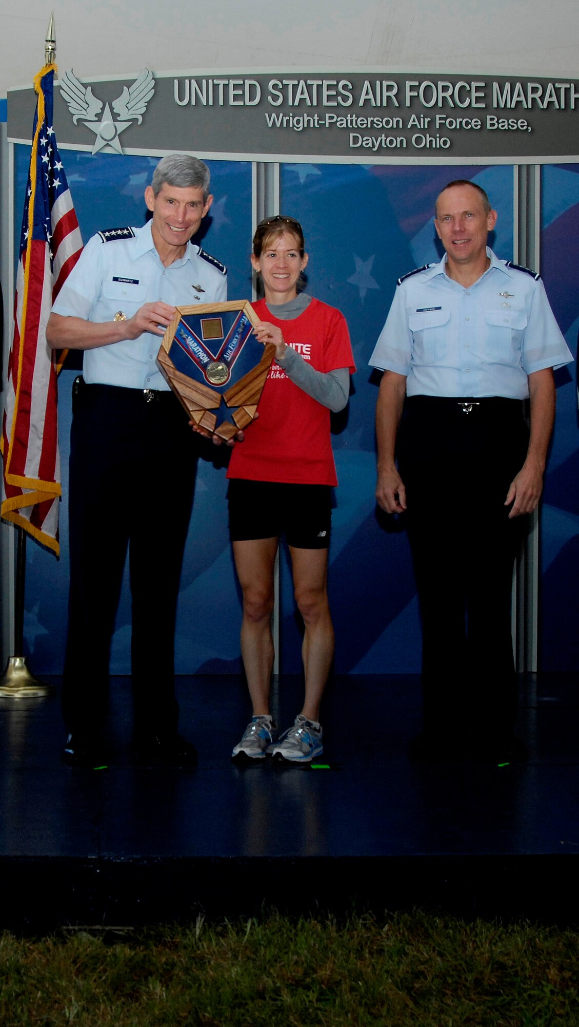 Kara Storage receives her trophy from Air Force Chief of Staff Gen. Norton Schwartz and Gen. Donald Hoffman (right), Commander of Air Force Materiel Command for winning the Women's half marathon Sept. 17.  Ms. Storage also set a new course record with a time of 1:15:56. (Air Force photo by Michelle Gigante)   
