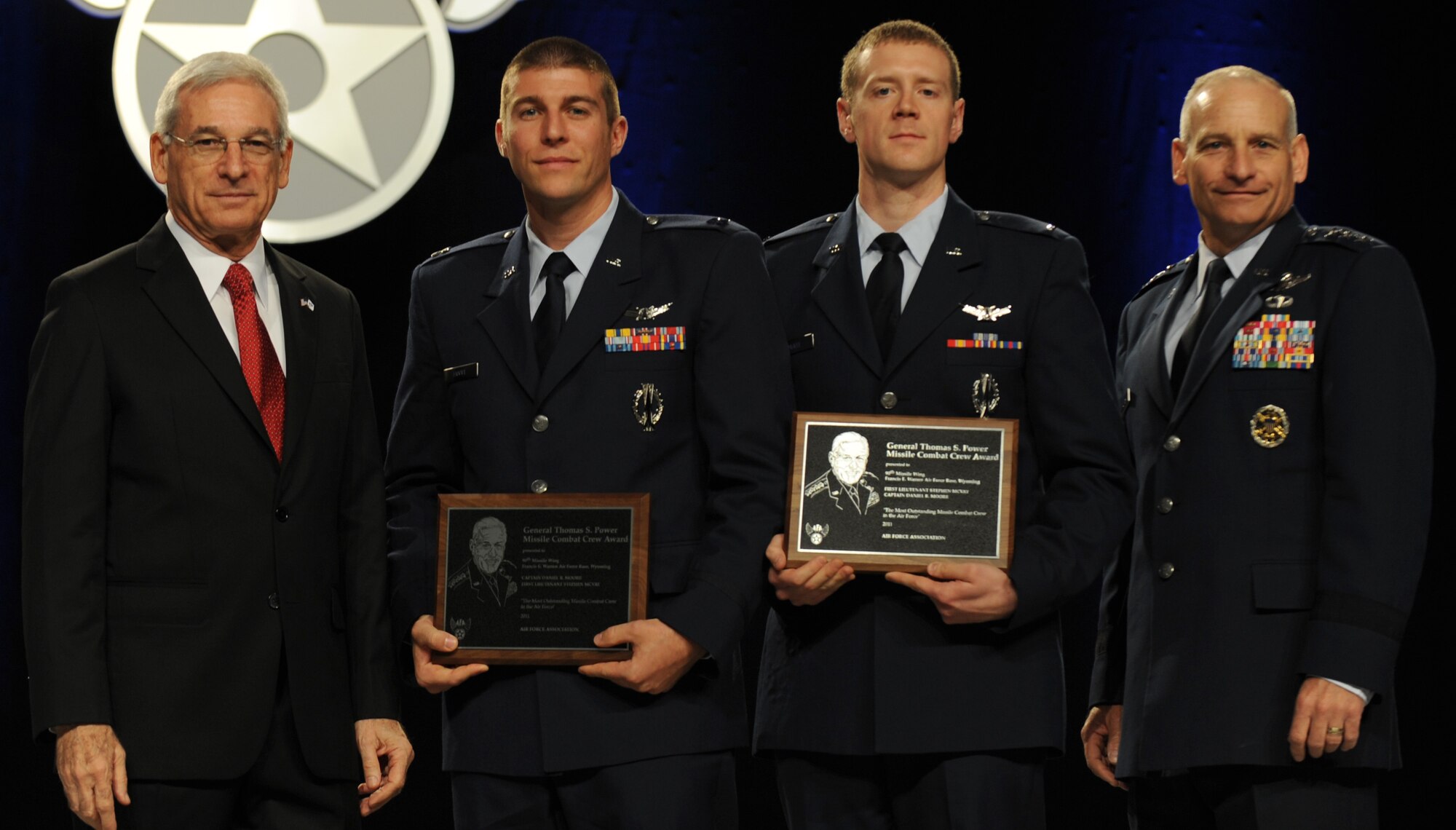 Lt. Gen. Jim Kowalski, commander of Air Force Global Strike Command, and Mr. S. Sanford Schlitt, Chairman of the Board for the Air Force Association, present the Gen. Thomas S. Power Award for the best missile combat crew to Capt. Daniel Moore and 1st Lt. Stephen McVay at the 2011 Air Force Association Air and Space Conference and Technology Exposition Sept. 20. The combat crew is from the 90th Missile Wing at F.E. Warren Air Force Base, Wyo.  (U.S. Air Force photo/Master Sgt. Thomas Coney)