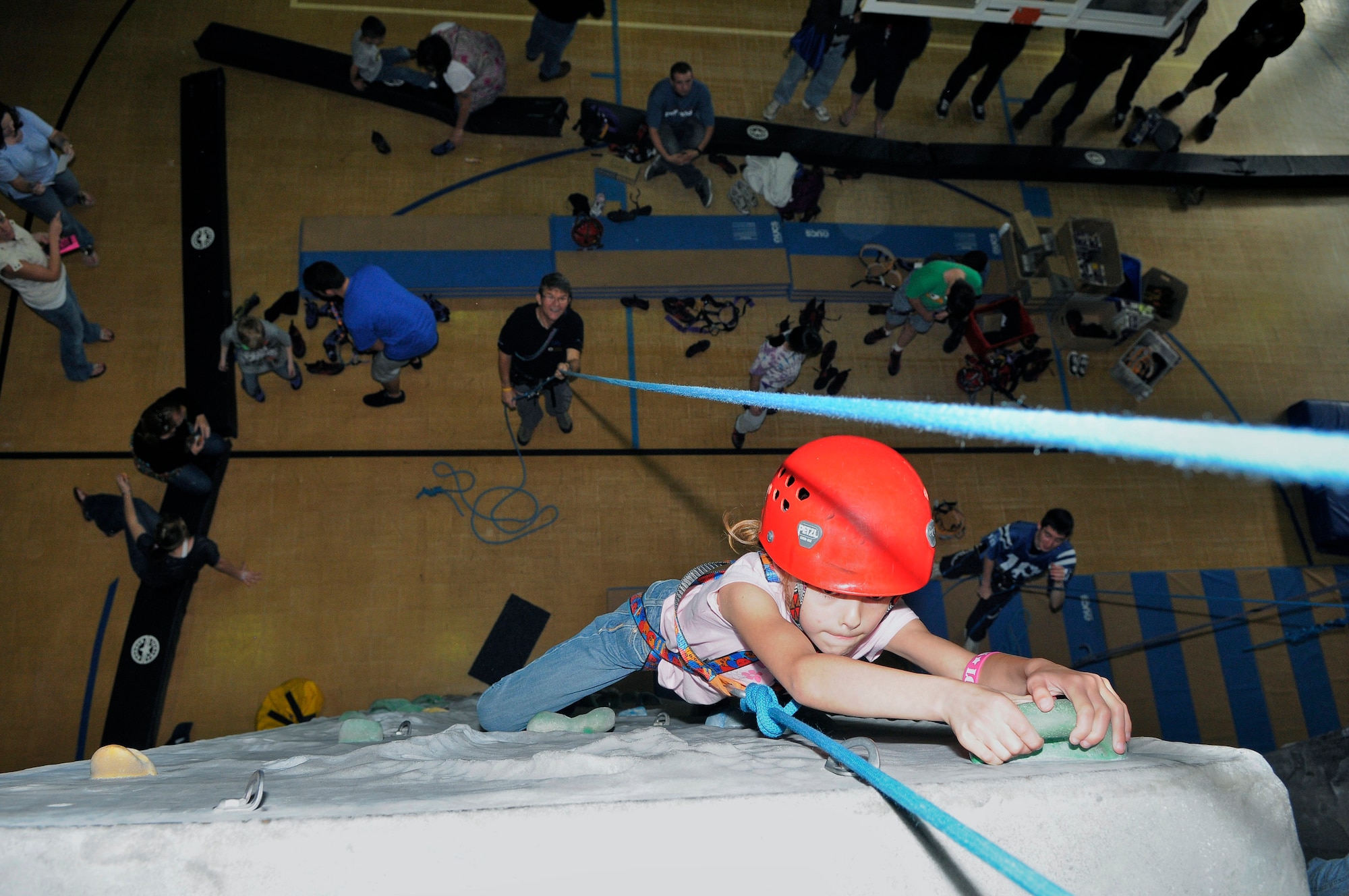 ROYAL AIR FORCE LAKENHEATH, England - Aubree Adams (6) climbs the rock wall at the RAF Lakenheath Youth Center during the World Wide Day of Play on Sept. 17, 2011.  The World Wide Day of Play is an annual event designed to encourage kids and parents to turn off the television, get out of the house, be active and play.  More than 450 Airmen and family members attended the event.  (U.S. Air Force photo by Staff Sgt. Connor Estes)