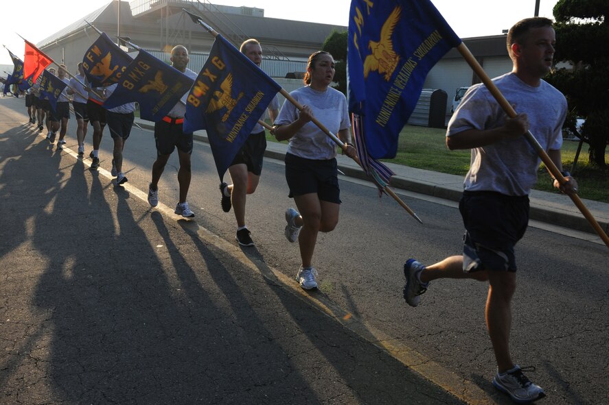 KUNSAN AIR BASE, Republic of Korea -- First sergeants from the 8th Fighter Wing run with their squadron flags after the warrior run here Sept. 16. The first sergeants ran the first leg of the 24-hour run in remembrance of the prisoners of war and missing in action servicemembers. (U.S. Air Force photo/Senior Airman Brittany Y. Bateman)