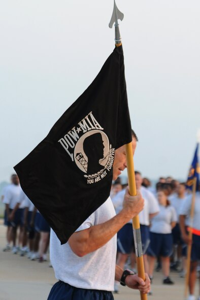 KUNSAN AIR BASE, Republic of Korea -- Col. Scott Pleus, 8th Fighter Wing commander, runs with the POW/MIA flag during the warrior run here Sept. 16. The warrior run was one event held to remember the prisoners of warrior and missing in action servicemembers because they are never forgotten. (U.S. Air Force photo/Senior Airman Brittany Y. Bateman)