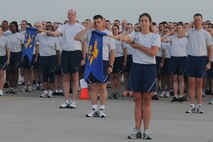 KUNSAN AIR BASE, Republic of Korea -- Members of the Wolf Pack salute during the playing of reveille before a warrior run here Sept. 16. The warrior run was one event held to remember the prisoners of warrior and missing in action servicemembers because they are never forgotten. (U.S. Air Force photo/Senior Airman Brittany Y. Bateman) 