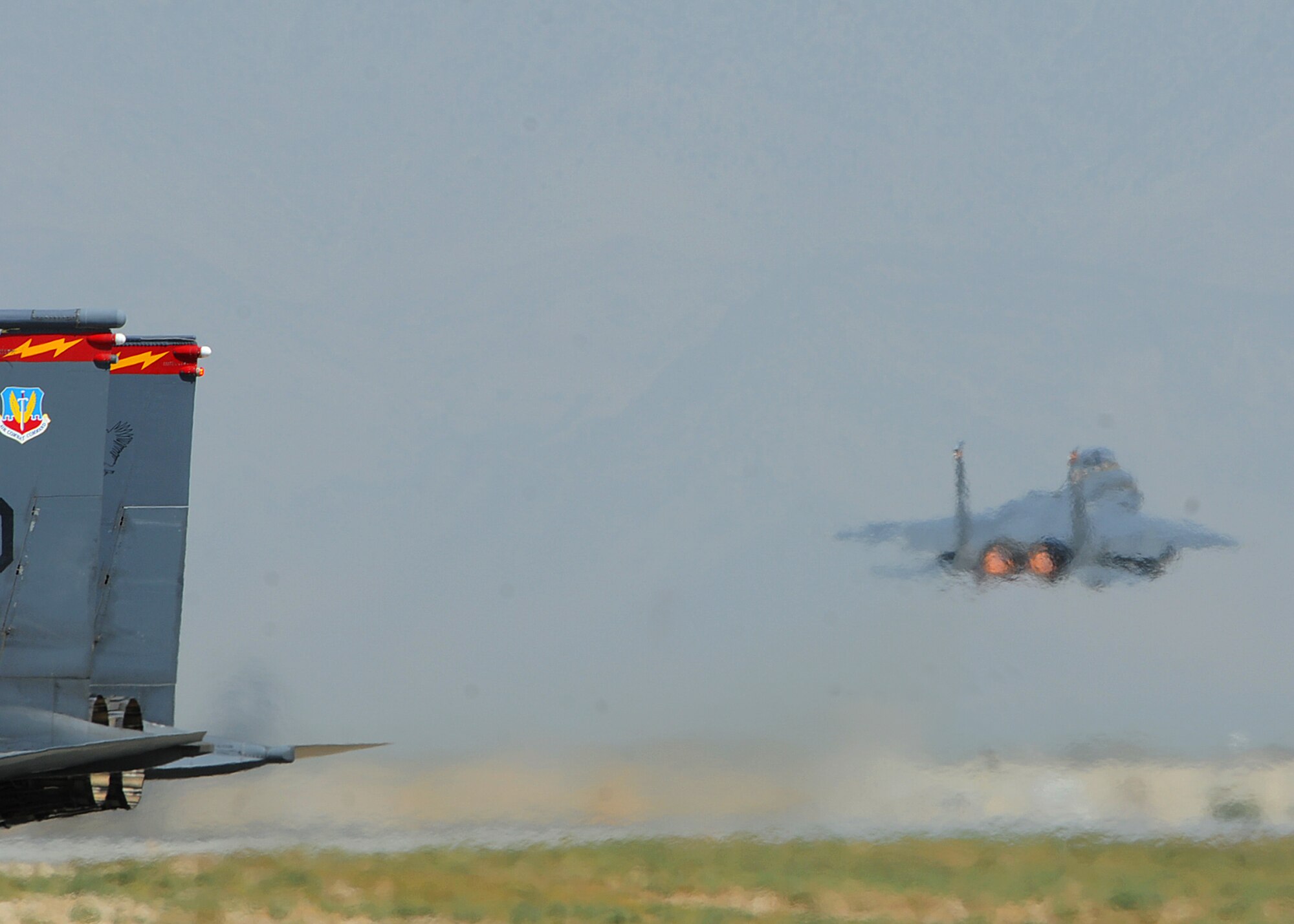 BAGRAM AIRFIELD, Afghanistan -- An F-15E Strike Eagle from the 389th Expeditionary Fighter Squadron takes off as a wingman taxies out to the runway in support of Operation Enduring Freedom here Sep. 20, 2011. The F-15 is a dual-role fighter designed to perform air-to-air and air-to-ground missions. It can penetrate enemy defense and outperform and outfight any current enemy aircraft. (U.S. Air Force photo/ Senior Airman Krista Rose)