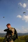 CHEONGJU, Republic of Korea -- A U.S. Air Force survival, evasion, resistance and escape instructor unhooks his parachute after landing at the drop zone here Sept. 15. The crews conducted aerial training missions to help keep themselves mission ready and qualified to ensure special operations forces members are up to date with their training requirements. (U.S. Air Force photo/Staff Sgt. Rasheen A. Douglas)