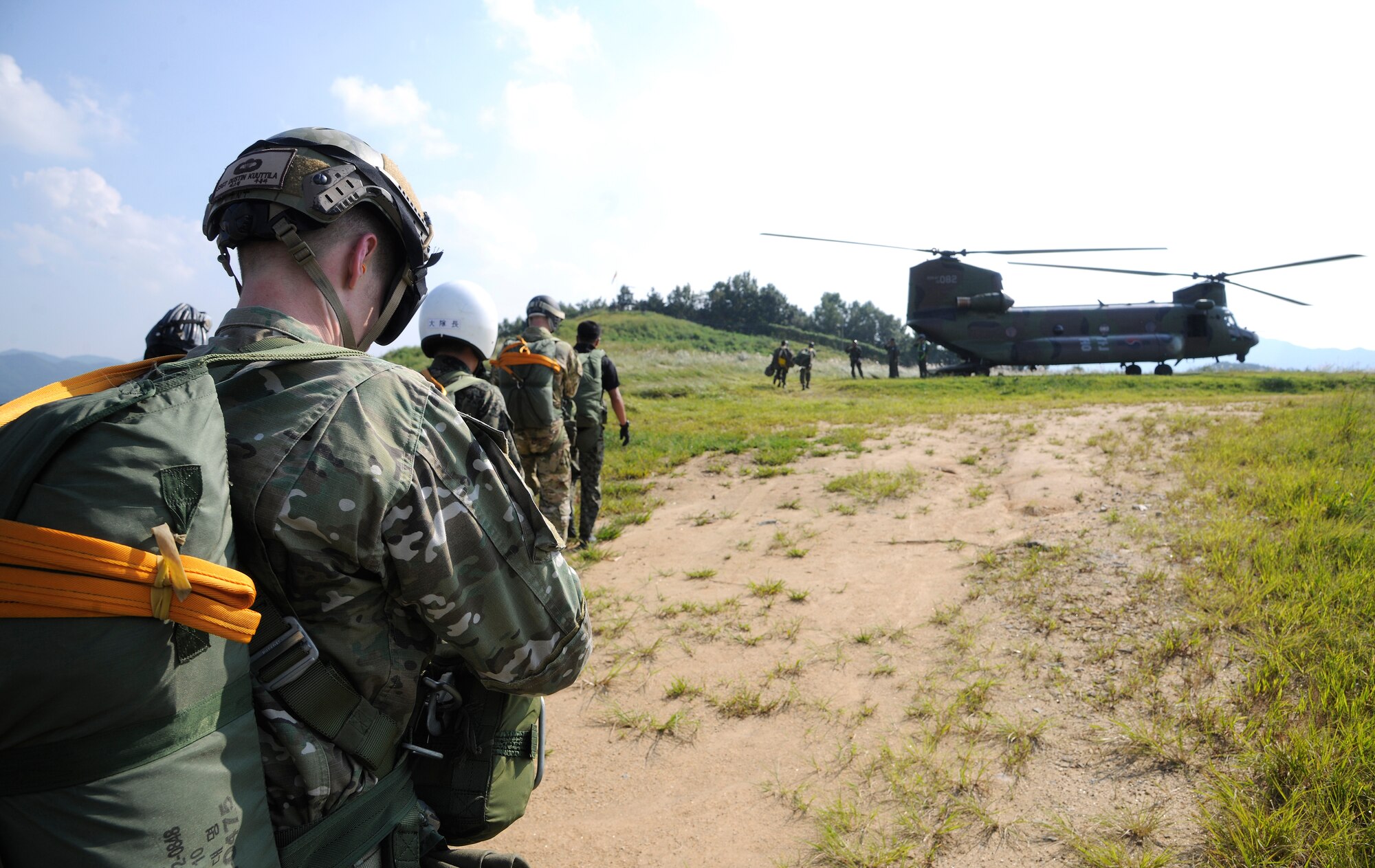 CHEONGJU, Republic of Korea -- A U.S. Air Force survival, evasion, resistance and escape instructor along with Republic of Korea Air Force SERE instructors prepare to board a ROKAF Chinook helicopter here Sept. 15. The U.S. Air Force and ROKAF performed a jump together helping improve relationships with one another and stimulate a continued bilateral partnership on the peninsula. (U.S. Air Force photo/Staff Sgt. Rasheen A. Douglas)