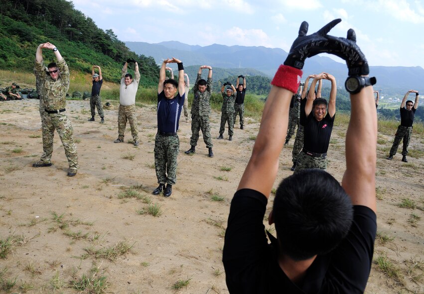 CHEONGJU, Republic of Korea -- U.S. Air Force and Republic of Korea Air Force survival, evasion, resistance and escape instructors stretch before performing their jumps here Sept. 15. The U.S. Air Force and ROKAF performed a jump together helping improve relationships with one another and stimulate a continued bilateral partnership on the peninsula. (U.S. Air Force photo/Staff Sgt. Rasheen A. Douglas)