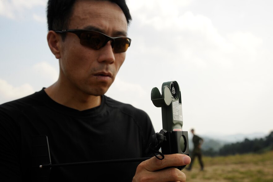 CHEONGJU, Republic of Korea -- A Republic of Korea Air Force survival, evasion, resistance and escape instructor uses an anemometer to check wind speeds on the drop zone to ensure it is safe to jump here Sept. 15. The crews conducted aerial training missions to help keep themselves mission ready and qualified to ensure special operations forces members are up to date with their training requirements. (U.S. Air Force photo/Staff Sgt. Rasheen A. Douglas)