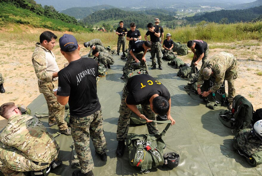 CHEONGJU, Republic of Korea -- U.S. Air Force and Republic of Korea Air Force survival, evasion, resistance and escape instructors prep their equipment to make their jumps here Sept. 15. The U.S. Air Force and ROKAF performed a jump together helping improve relationships with one another and stimulate a continued bilateral partnership on the peninsula. (U.S. Air Force photo/Staff Sgt. Rasheen A. Douglas)
