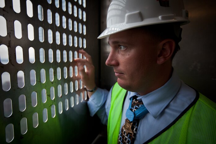 NEW YORK --  Sgt. Dakota Meyer, the first living Marine to be awarded the Medal of Honor for actions since Vietnam, looks out a construction elevator during a tour of the Freedom Tower, Sept. 21. Meyer spoke at a ceremony at the National September 11 Memorial & Museum before touring the Freedom Tower. During his speech he told the audience of mostly veterans, firefighters, police and construction workers, "people have been calling me a hero a lot lately, but you are the real heroes... If this is what being a hero feels like, you can have it." For more information, visit www.dakotameyer.com. (Official Marine Corps photo by Sgt. Randall A. Clinton / RELEASED)