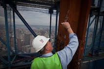 NEW YORK --  Sgt. Dakota Meyer, the first living Marine to be awarded the Medal of Honor for actions since Vietnam, signs a beam at the top of the Freedom Tower, Sept. 21.  Meyer spoke at a ceremony at the National September 11 Memorial & Museum before touring the Freedom Tower. During his speech he told the audience of mostly veterans, firefighters, police and construction workers, "people have been calling me a hero a lot lately, but you are the real heroes... If this is what being a hero feels like, you can have it." For more information, visit www.dakotameyer.com. (Official Marine Corps photo by Sgt. Randall A. Clinton / RELEASED)