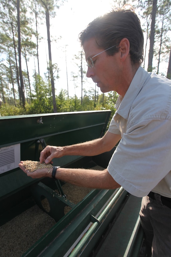 Marty Korenek, a wildlife manager with Land & Wildlife Resources Section, Environmental Management Division aboard Marine Corps Base Camp Lejeune, holds up seeds that will be planted on various food plots aboard the base. The food plots will provide nutrients to animals during the cold winter months.