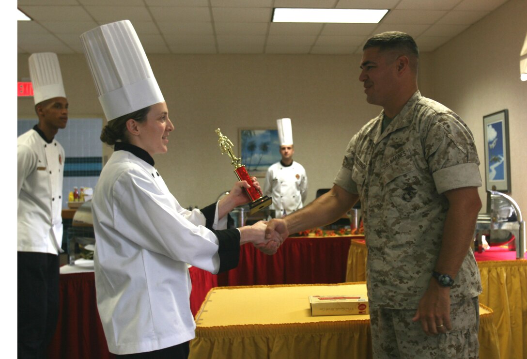 At the conclusion of the competition, Lt. Col Steven J. Himelspach, Headquarters and Headquarters Squadron executive officer, awards Lance Cpl. Hanna Block the 1st place trophy and a garnish tool kit.
