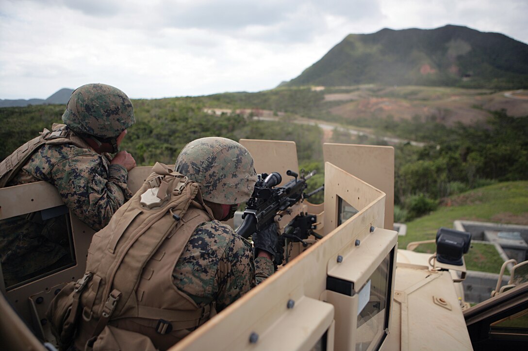 Cpl. Justin Little and Lance Cpl. Lars Miles conduct a live-fire shoot with the M249 squad automatic weapon during Exercise Roaring Lion in the Central Training Area Sept. 22. The exercise was designed to prepare the Marines for combat convoy operations in Afghanistan. Little and Miles are motor transport operators with Marine Wing Support Squadron 172, Marine Wing Support Group 17, 1st Marine Aircraft Wing, III Marine Expeditionary Force.