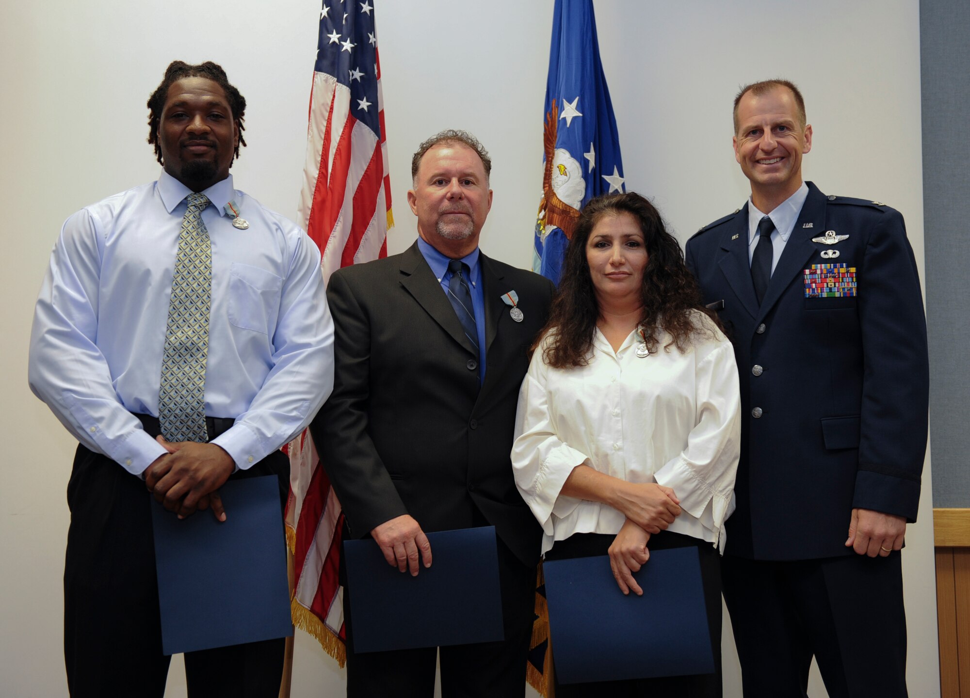 008. (From left) Arnell Carmichael, Joseph Morrison and Maria Rendon pose with  Col. Corey Martin, 18th Wing vice commander, after receiving awards of valor at a ceremony on Kadena Air Base, Japan, Sept. 20, 2011. Because of their quick and smart actions, the three were able to help save a staff sergeant who had accidently been pinned between two vehicles last January. (U.S. Air Force photo/Airman 1st Class Brooke P. Beers)