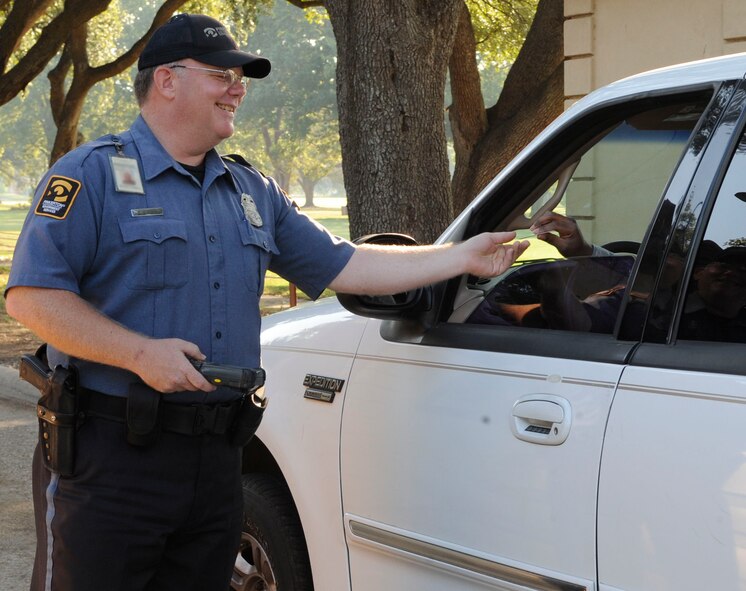 Daniel Snyder, contract security guard on Barksdale Air Force Base, La., scans an identification card Sept. 22 to ensure unauthorized personnel don?t gain access to the base.  Beginning Oct. 1, the new civilian security officers and military police will secure the gate posts on base. (U.S. Air Force photo/Airman 1st Class Andrea F. Liechti) (RELEASED)