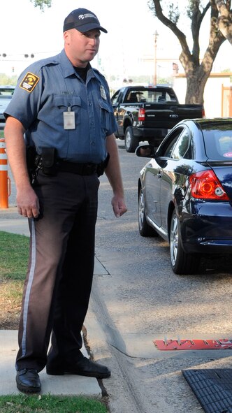 Donald Heaser, contract security guard on Barksdale Air Force Base, La., keeps an eye out for a suspicious vehicle Sept. 22.  This is one of the many jobs the new civilian security officers and military police will take over beginning Oct. 1. (U.S. Air Force photo/Airman 1st Class Andrea F. Liechti) (RELEASED)