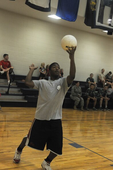 Derico English, 723rd Aircraft Maintenance Squadron, prepares to serve a ball during an intramural volleyball championship game at Moody Air Force Base, Ga., Sept. 21, 2011. The 723rd AMXS found themselves down by three before scoring three consecutive points including an ace to tie the game. An ace is when a point is scored off of a serve. Despite the effort, the 23rd Medical Group defeated the 723rd AMXS in a best of three sets to become Moody intramural volleyball champions. (U.S. Air Force photo by Airman 1st Class Paul Francis/Released)
