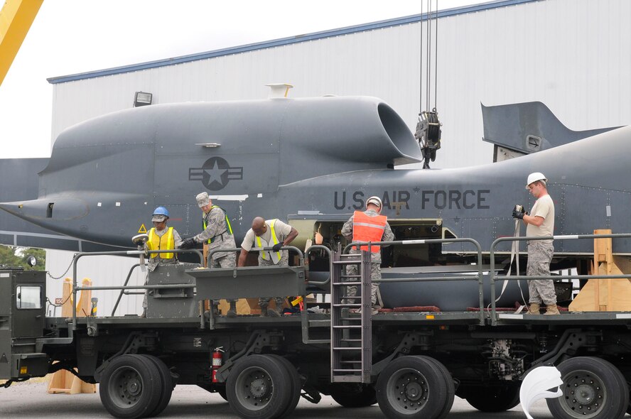 Members of the 78th Logistics Readiness Squadron prepare the Global Hawk to be unloaded at the Museum of Aviation  Sept. 20. U. S. Air Force photo by Sue Sapp