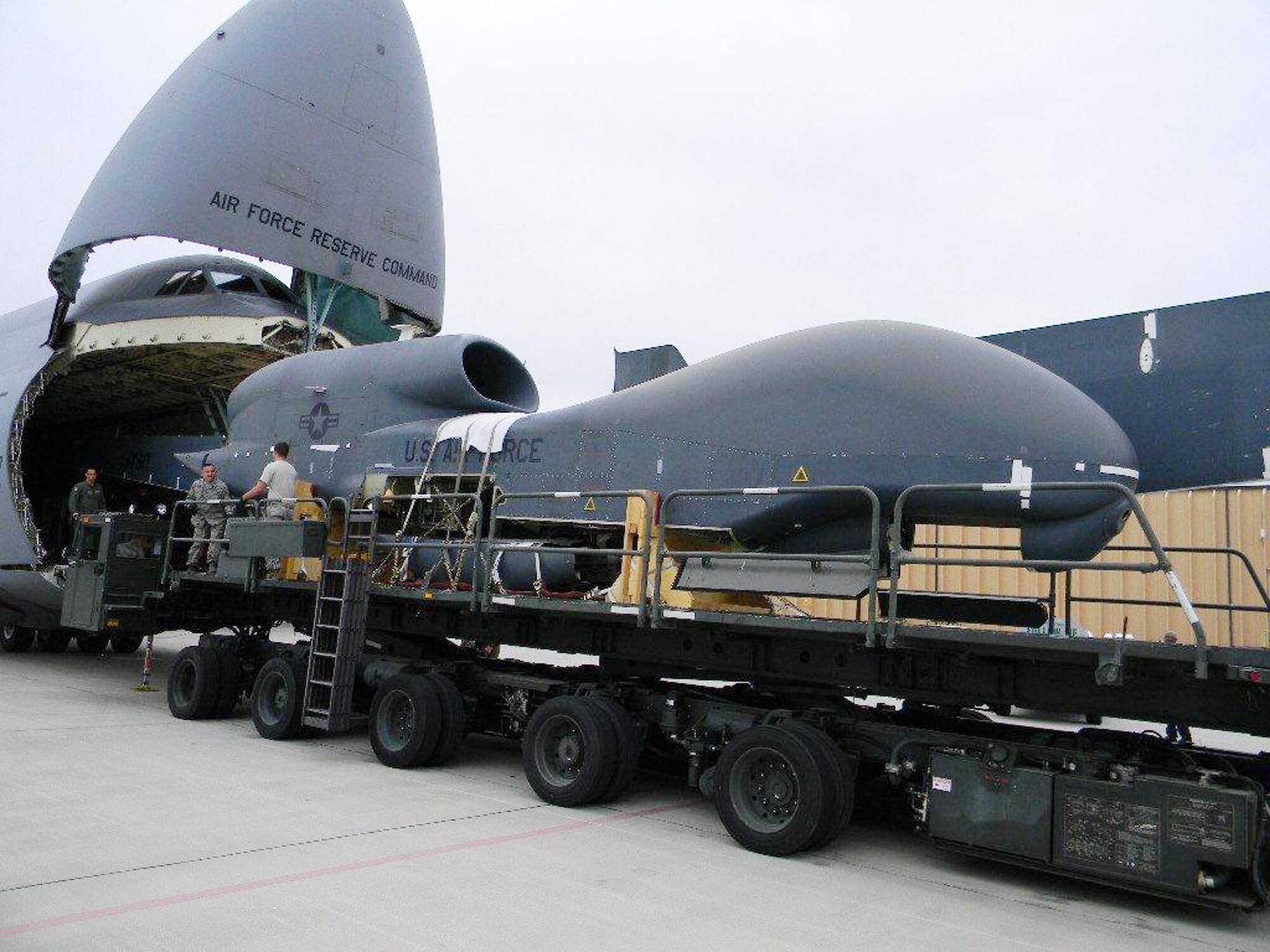 The RQ-4 Global Hawk, bound for the Museum of Aviation, is unloaded from a C-5 Galaxy on the Robins flightline. U. S. Air Force photo