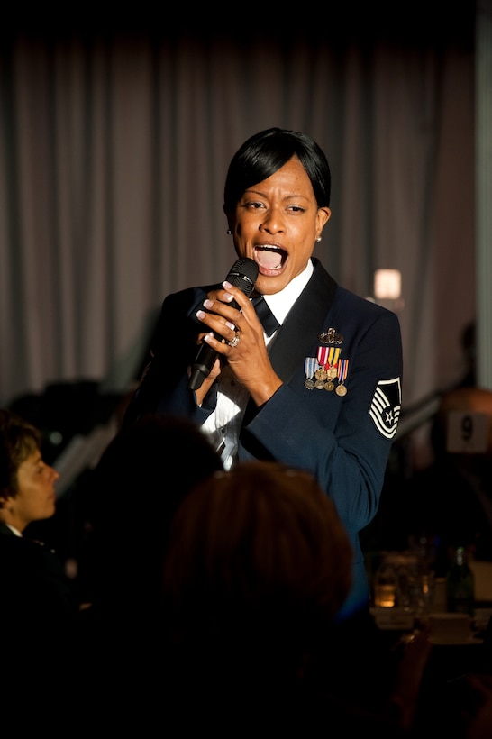 JOINT BASE ANACOSTIA-BOLLING, Washington -- Master Sgt. Kimberly
Muhlecke, U.S Air Force ceremonial guardsman chief, 11th Wing Joint Base
Anacostia Bolling  sings a tribute song at the 2011 Air Force Birthday Ball
held at the JBAB Club Sept. 16. (Photo by Bobby Jones)
