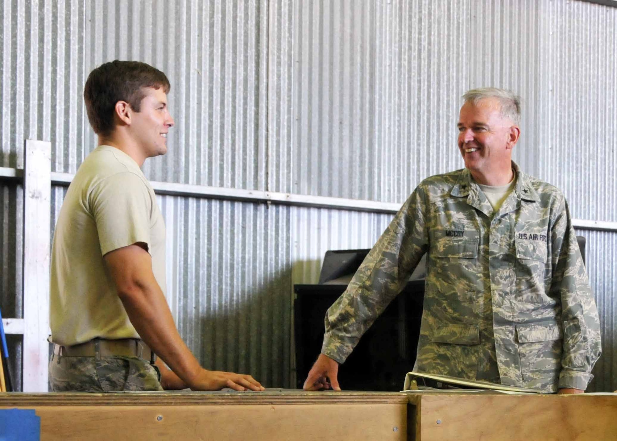 Brig. Gen. John E. McCoy, Assistant Adjutant General for Air, Wisconsin Air National Guard talks with Staff Sgt. Joshua A. Jeter during a visit to the 313th Air Expeditionary Wing in Western Europe on Saturday, July 30, 2011.