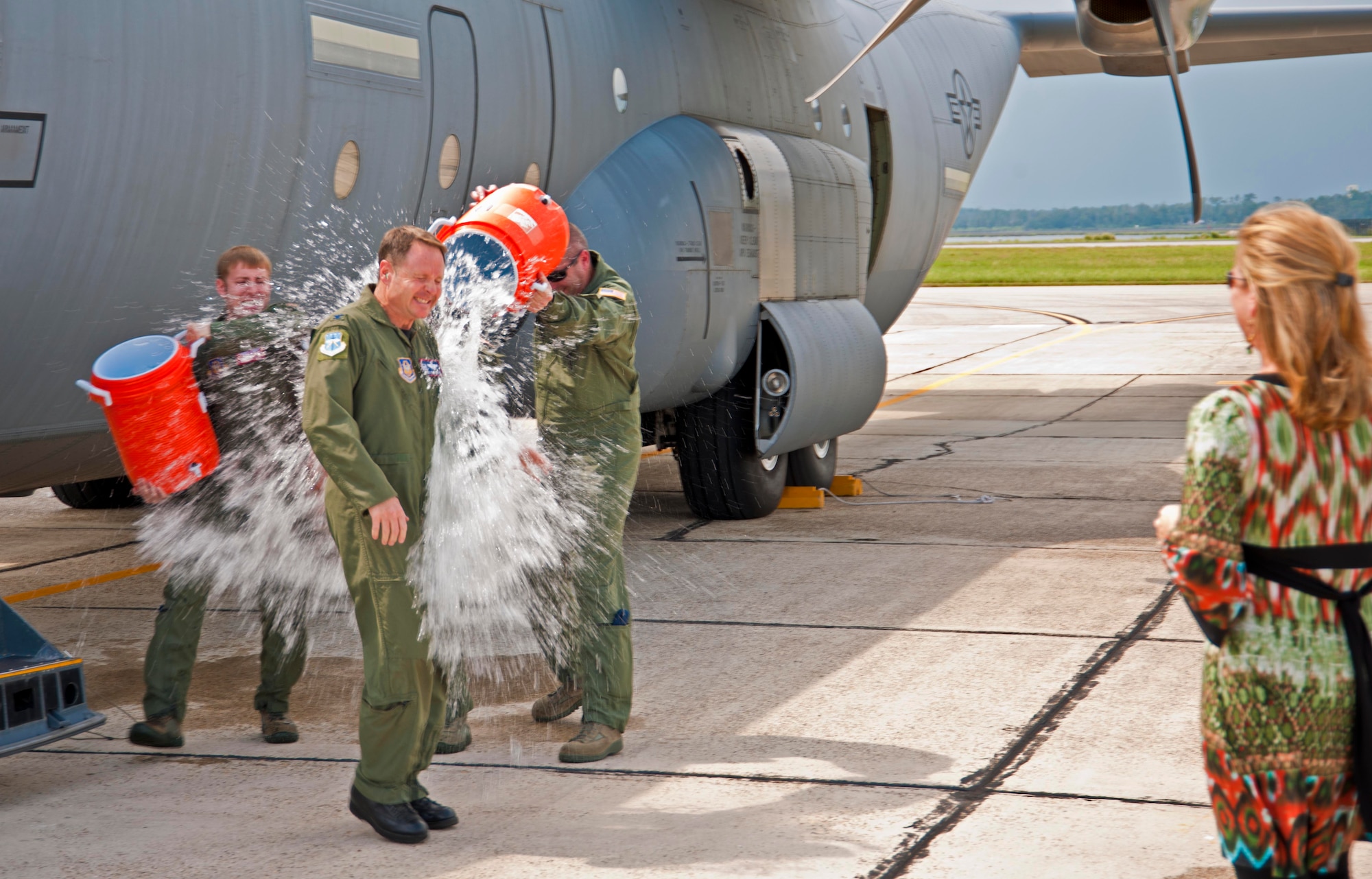 Col. Louis Patriquin, 403rd Wing Operations Group commander, is doused with water by members of the 345th and 815th Airlift Squadrons after completing his final flight on a C-130J-30 Sept. 20, 2011 as a member of the 403rd Wing. Patriquin leaves Keesler Air Force Base, Miss., for his new assignment at Robins Air Force Base, Ga., where we will serve as the executive assistant to Lt. Gen. Charles Stenner, Air Force Reserve Command commander. (U.S. Air Force photo by Tech. Sgt. Tanya King)