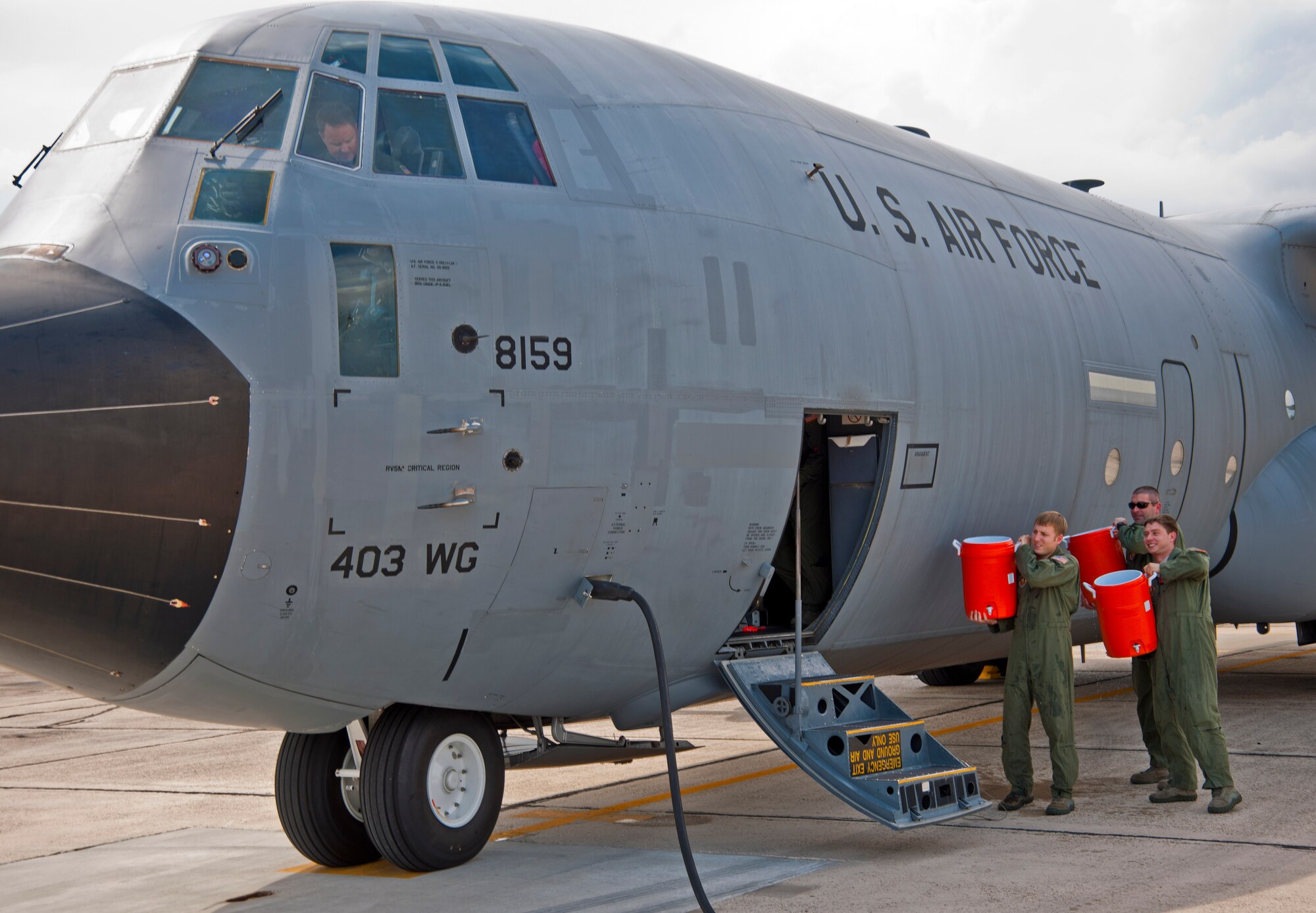 Members of the 815th Airlift Squadron await Col. Louis Patriquin, 403rd Wing Operations Group commander, to douse him with water by after completing his final flight Sept. 20, 2011 on a C-130J-30 as a member of the 403rd Wing. Colonel Patriquin's leaves Keesler Air Force Base, Miss. for his new assignment at Robins Air Force Base, Ga., where he will serve as the executive assistant to Lt. Gen. Charles Stenner, Air Force Reserve Command commander. (U.S. Air Force photo by Tech. Sgt. Tanya King)