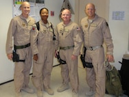 Two Airmen from the 916th Air Refueling Wing Security Forces Squadron pose with leadership from the 451st Expeditionary Mission Support Group. The Airmen were cleaning up door rooms and barracks in their deployed location. (USAF photo courtesy of 916SF)