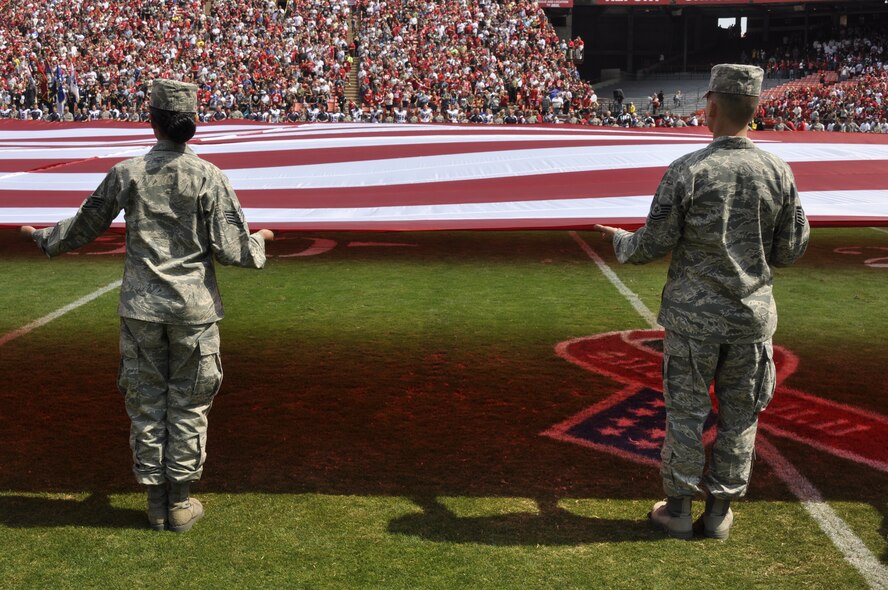 California Air National Guardsmen from the 129th Rescue Wing, Moffett Federal Airfield, Calif., and Airmen from Travis Air Force Base, Calif., participate in a flag ceremony in rememberance of the Sept. 11th terrorist attacks, Candlestick Park, San Francisco, Calif., Sept. 11, 2011.  Approximately 200 Airmen from the 129th Rescue Wing and from Travis Air Force Base, Calif., took part in the ceremony.  (Air National Guard Photo by Airman 1st Class John Pharr)