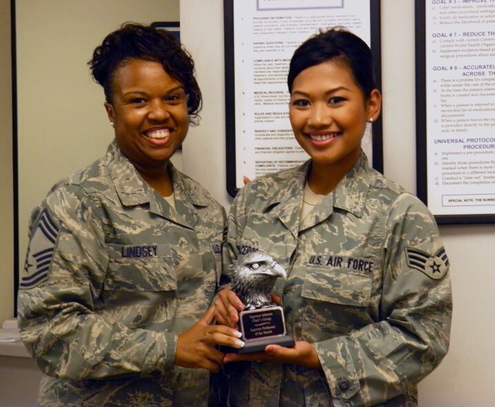 Chief Master Sgt. Bionca Lindsey awards Senior Airman Armelyn Braceros with a Chief's Group Superior Performer award Sept. 14, 2011. Braceros is the only health services management technician in her section and is in charge of the daily schedules for six flight surgeons and maintains the medical records for more than 1,500 active duty personnel and their families. She also manages the Personnel Reliability Program (PRP) for the entire 4th Medical Group (4th MDG), which includes ensuring Airmen and civilians who work in career fields with certain security requirements are medically qualified to do their jobs. Lindsey is the 4th MDG superintendent from Chicago and Braceros is a health services management technician with the 4th Aerospace Medicine Squadron and hails from Honolulu. (Courtesy photo) 