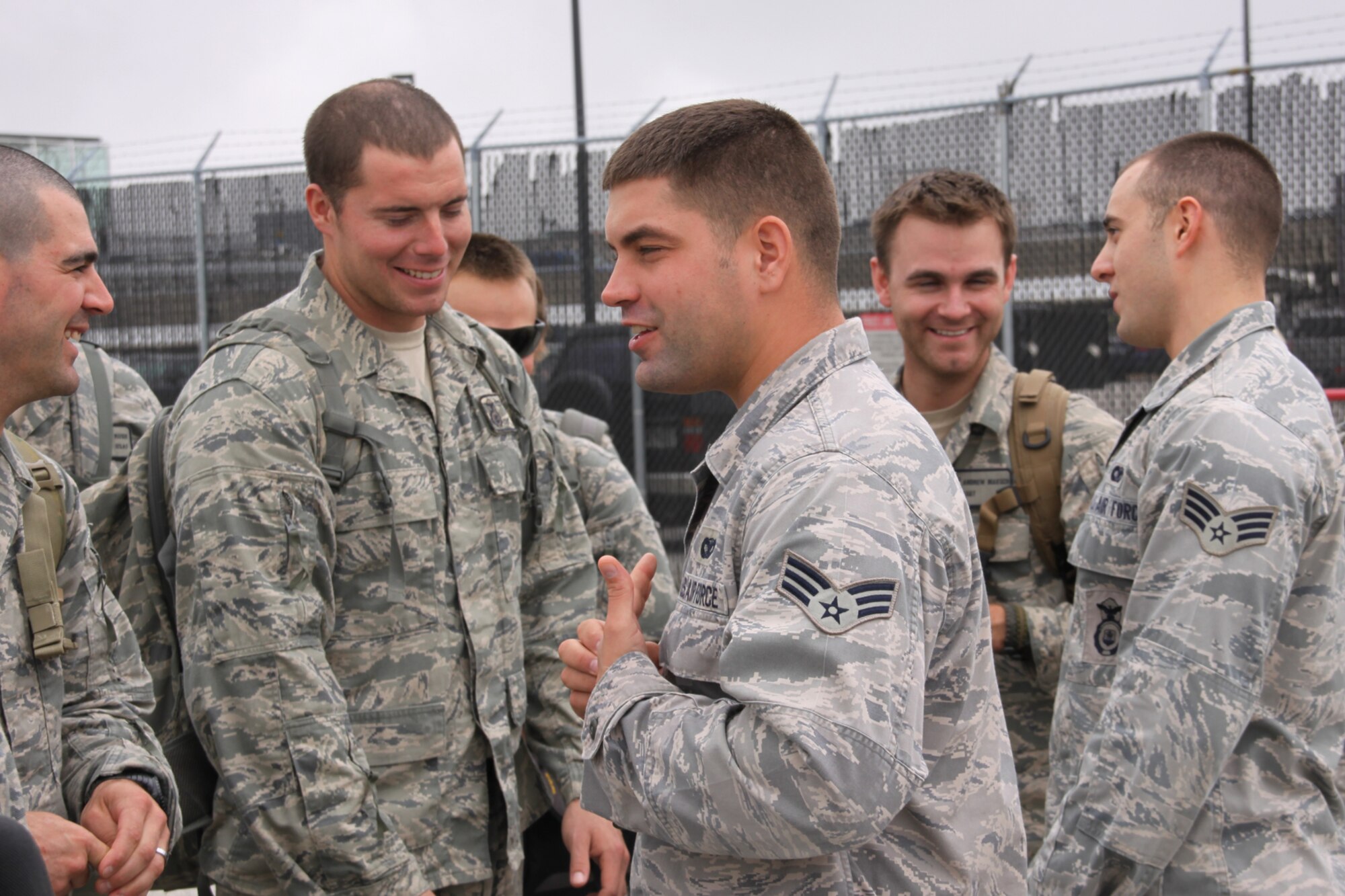 PITTSBURGH IAP ARS -- Senior Airman Keith Graft (center facing left) and Senior Airman Domenic Mash (far right) greet members of a Security Forces squad in Baltimore, Md., Sept. 21. The team reunited for the last leg of their journey home, Sept. 21. Graft and Mash had returned from overseas a week earlier than the rest of the squad to surprise their wives and be introduced to their newborn children on HLN's “Morning Express with Robin Meade,” Sept. 14. (U.S Air Force/Senior Airman Jonathan Hehnly)
