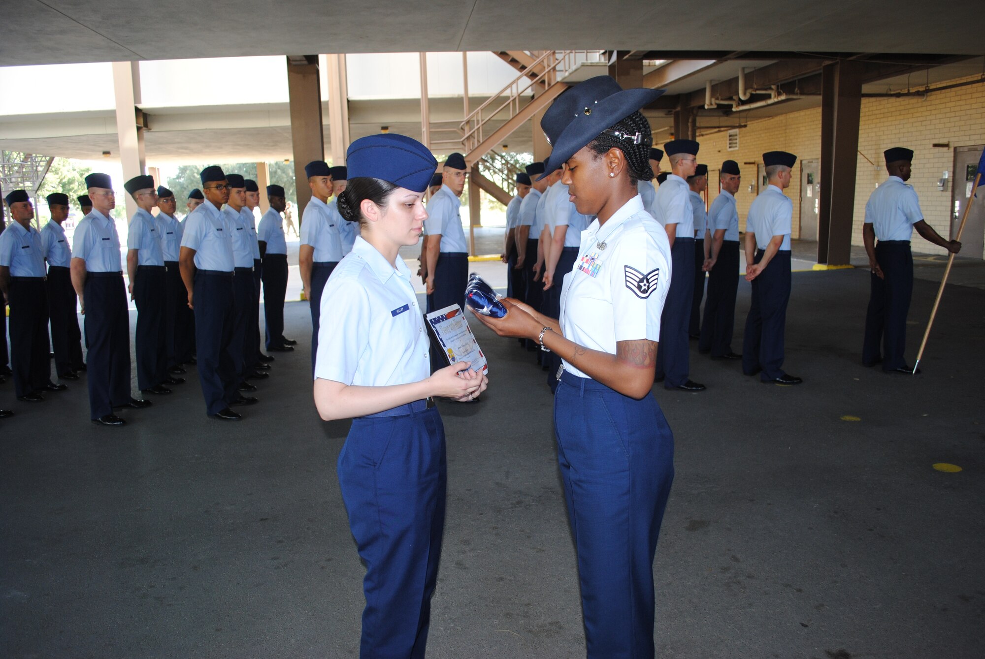 Staff Sgt. Tamisha Rutledge, 331st Training Squadron military training instructor, presents, Airman Basic Trisha Kelley, 331st TRS basic military training trainee, an American flag on the formation pad at the 331st TRS headquarters building, Sept. 22, 2011 at Lackland Air Force Base, Texas. 

The flag was presented as a surprise on behalf of Airman Kelley’s husband, Senior Airman Justin Kelley, who is currently deployed to Southwest Asia. The flag was flown over Lackland AFB on Sept. 19 aboard a C-5A Galaxy assigned to the 433rd Airlift Wing.  

A commemorative certificate accompanied the flag. Both items were presented to the Airman Kelley in honor of her graduation from Air Force basic military training. (U.S. Air Force photo/Senior Airman Luis Loza Gutierrez) 