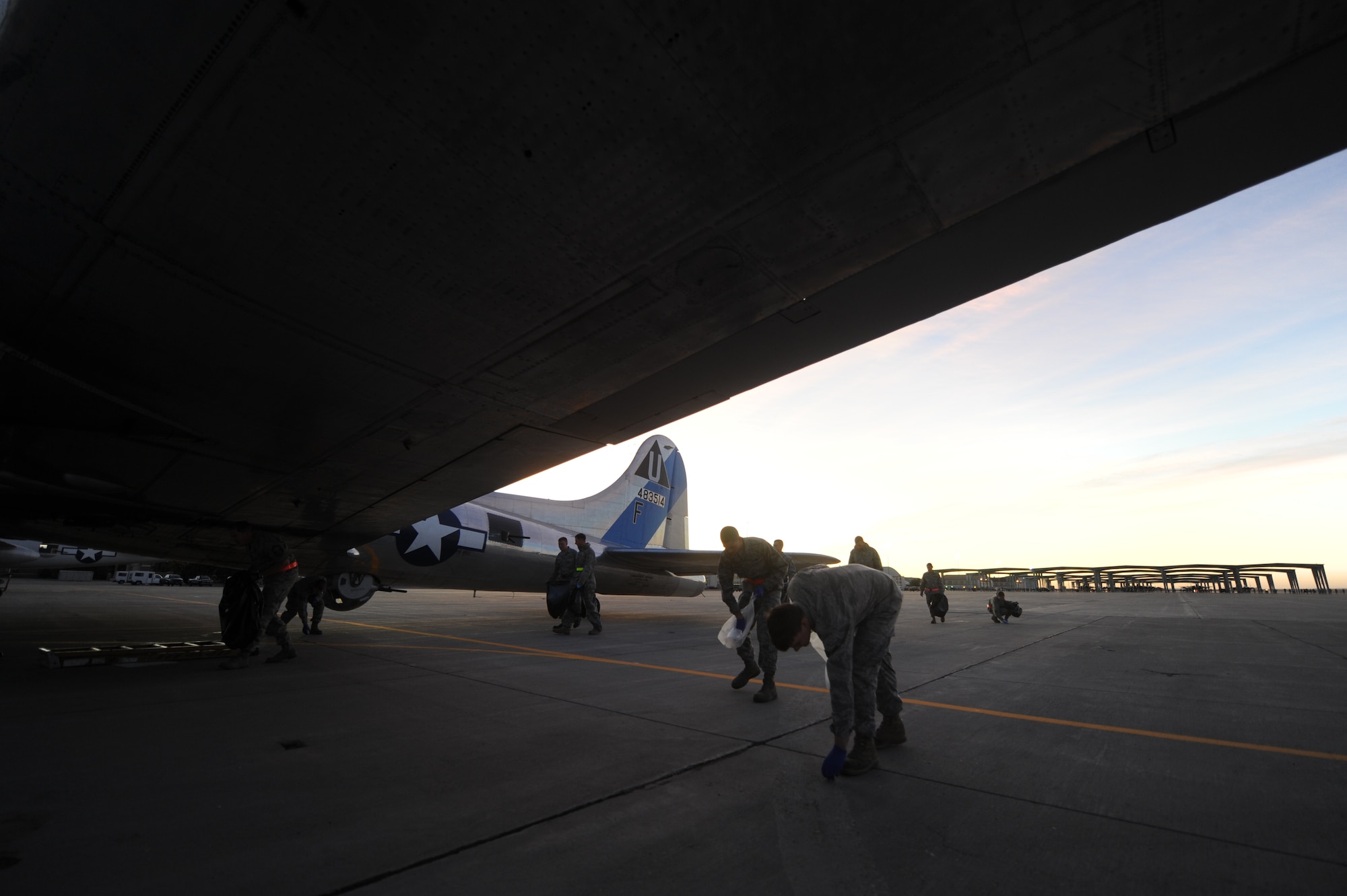 Gunfighters from Mountain Home Air Force Base, perform a foreign object debris walk after Gunfighter Skies 2011 open house here Sept. 19. Any debris, such as ear plugs or food wrappers, must be removed before aircraft can use the flightline. (U.S. Air Force photo by Staff Sgt. Gina Chiaverotti-Paige)