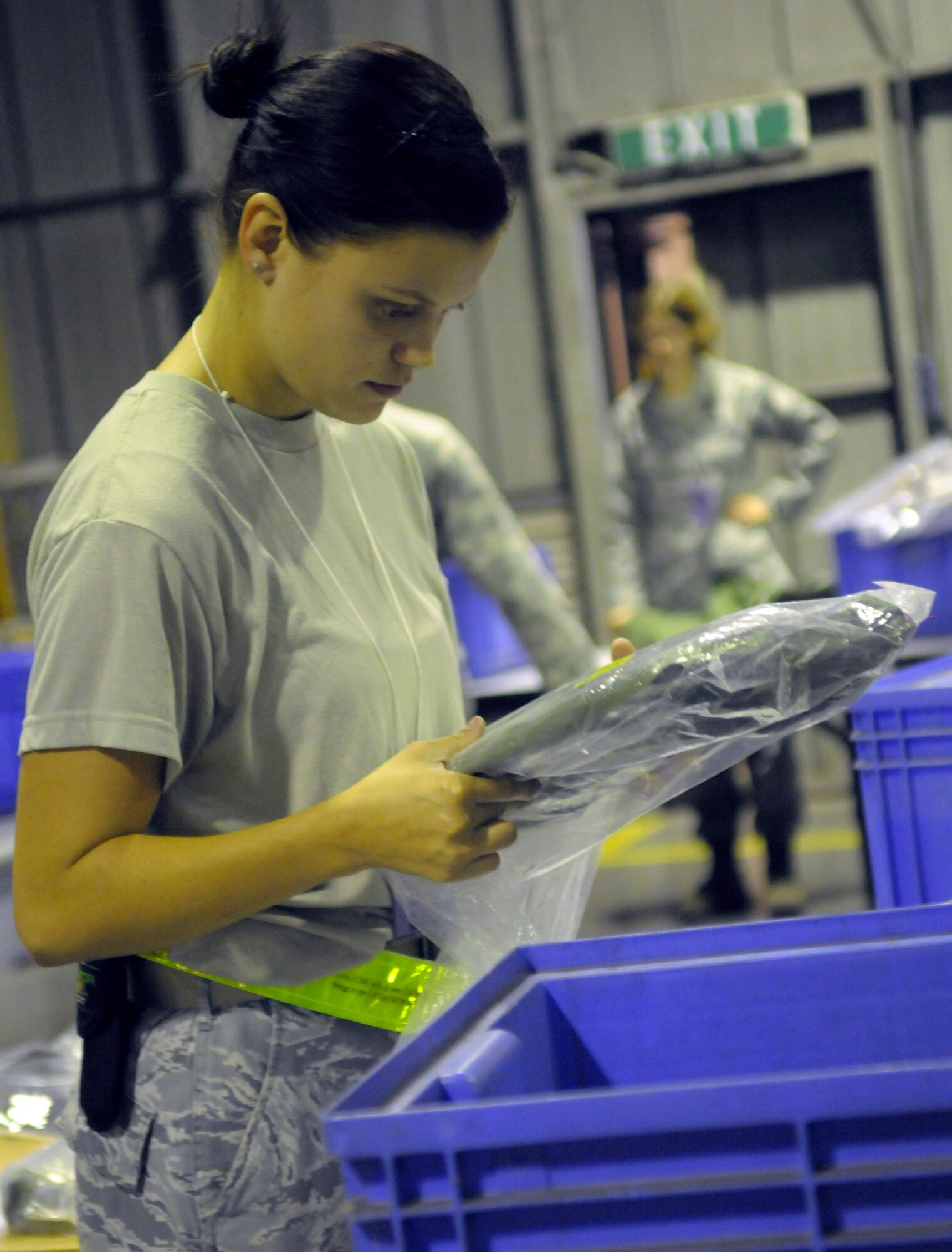 Airman 1st Class Codi Walach, 31st Logistics Readiness Squadron individual protective equipment technician, checks for lot numbers and expiration dates as she hands out deployment gear during an operational readiness exercise Sept. 21 at Aviano Air Base, Italy. Walach is part of the processing deployment function team.(U.S. Air Force photo/Airman 1st Class Briana Jones)