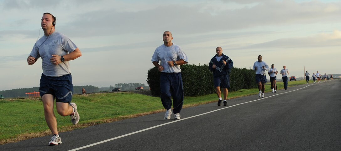 Volunteers run during the Combined Federal Campaign 5K Run, Langley Air Force Base, Va., Sept. 22, 2011. Pledges to the CFC made by Federal civilian, postal and military donors support eligible non-profit organizations that provide health and human service benefits throughout the world. (U.S. Air Force photo by Airman 1st Class Teresa Cleveland/Released)