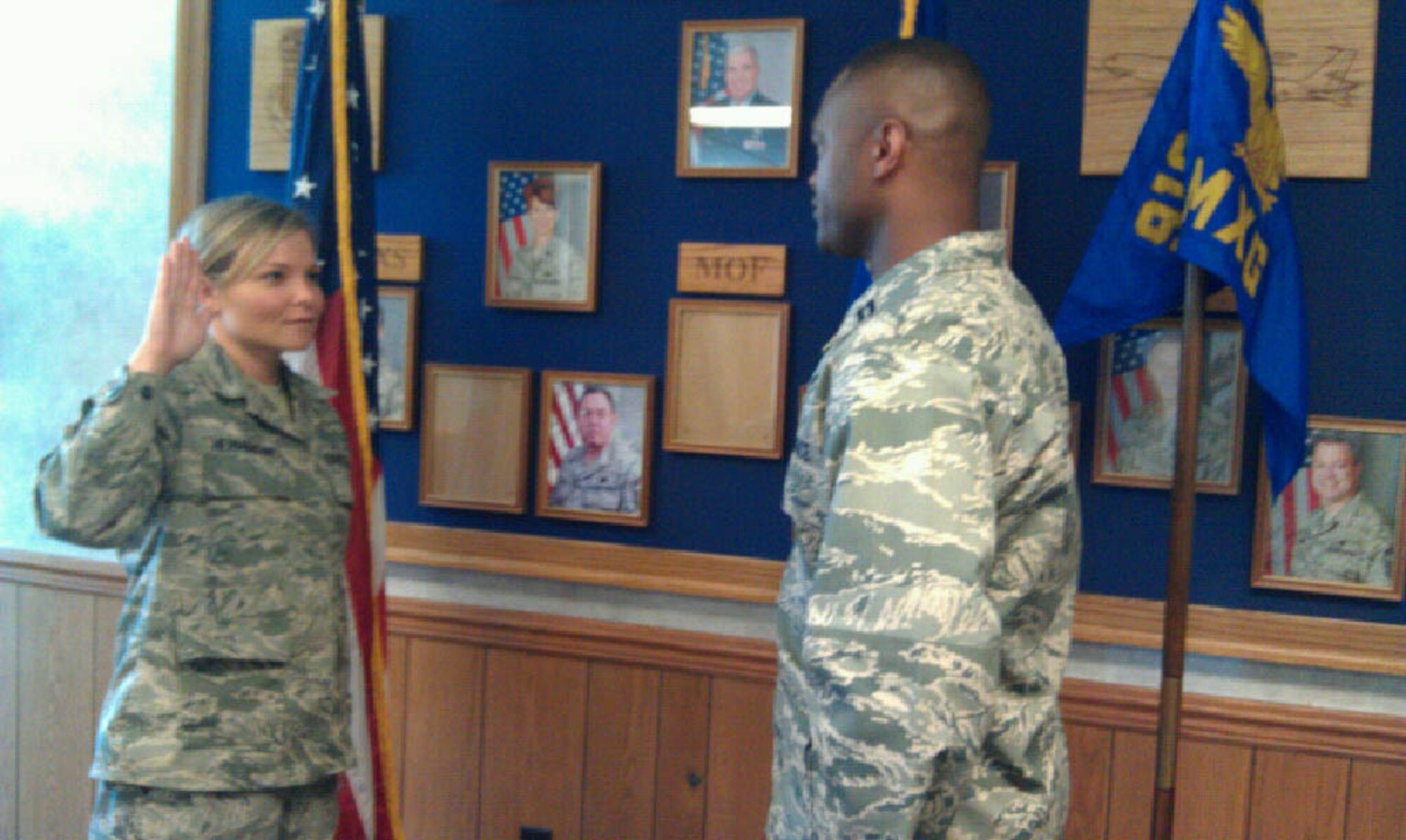 Staff Sgt. Holly Hermanson takes the oath of re-enlistment from Capt. Jarius Wallace in mid-September. Hermanson is a member of the 916th Maintenance Squadron. (USAF photo courtesy of 916MXS)