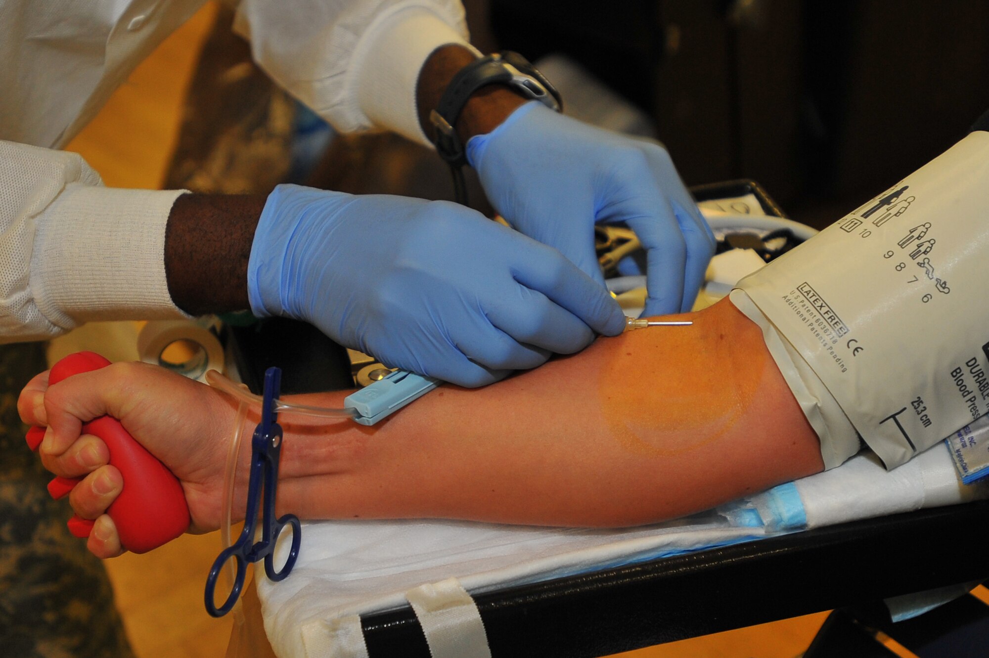 SPANGDAHLEM AIR BASE, Germany – A Landstuhl Regional Medical Center lab technician sticks a needle into a donor during the Spangdahlem Blood Drive here Sept. 21. The Armed Forces Blood Drive is a worldwide joint operation organized by the Armed Services Blood Program to collect, process, store, distribute and transfuse blood to different locations across the globe. (U.S. Air Force photo/Airman 1st Class Dillon Davis)