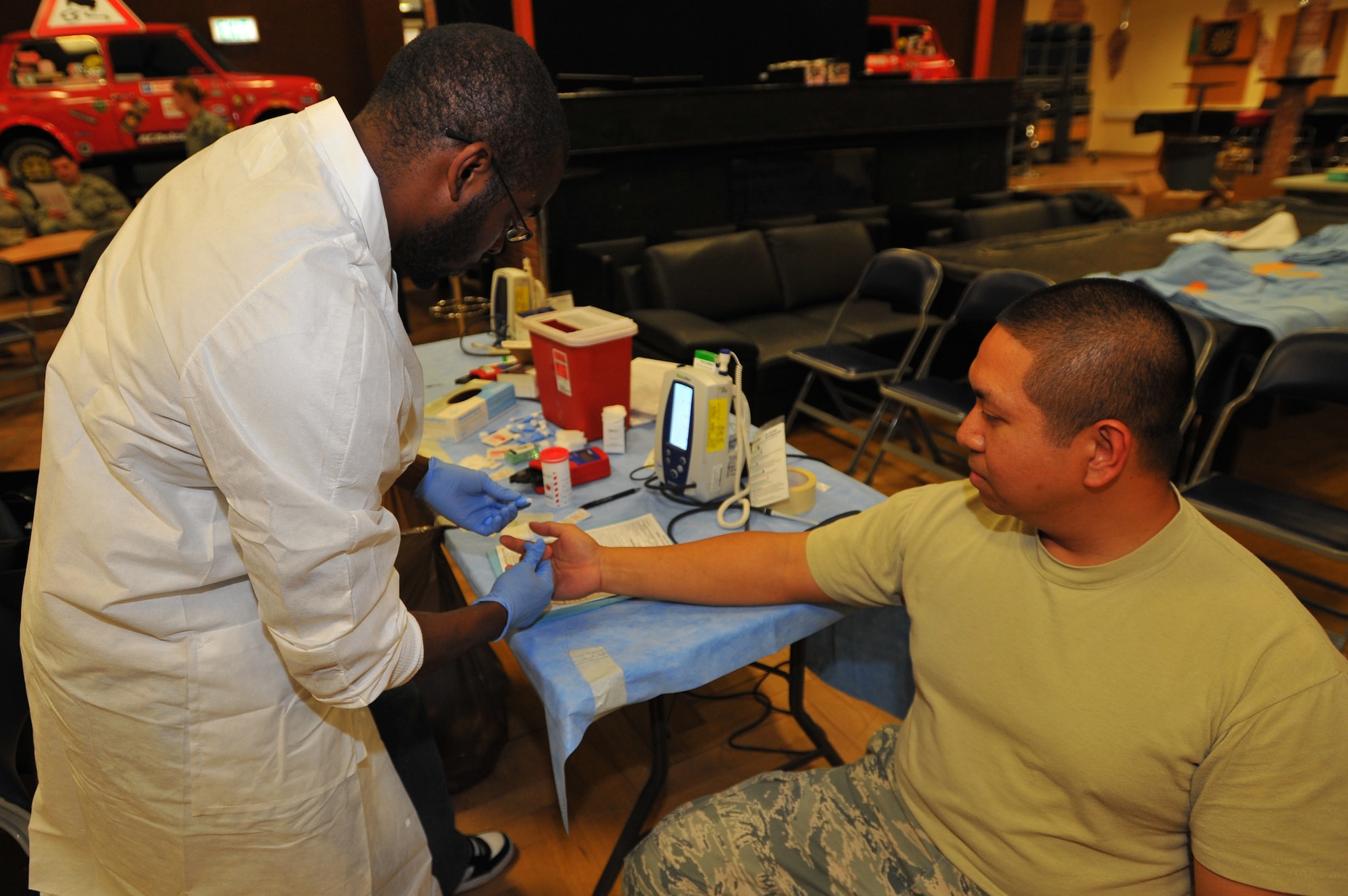 SPANGDAHLEM AIR BASE, Germany – Leonard Little, left, Landstuhl Regional Medical Center lab technician, tests the iron count of Tech. Sgt. Ryan Ancheta, 52nd Civil Engineer Squadron, to ensure he will be able to participate in the Spangdahlem Blood Drive here Sept. 21. The Armed Forces Blood Drive is a worldwide joint operation organized by the Armed Services Blood Program to collect, process, store, distribute and transfuse blood to different locations across the globe. (U.S. Air Force photo/Airman 1st Class Dillon Davis)
