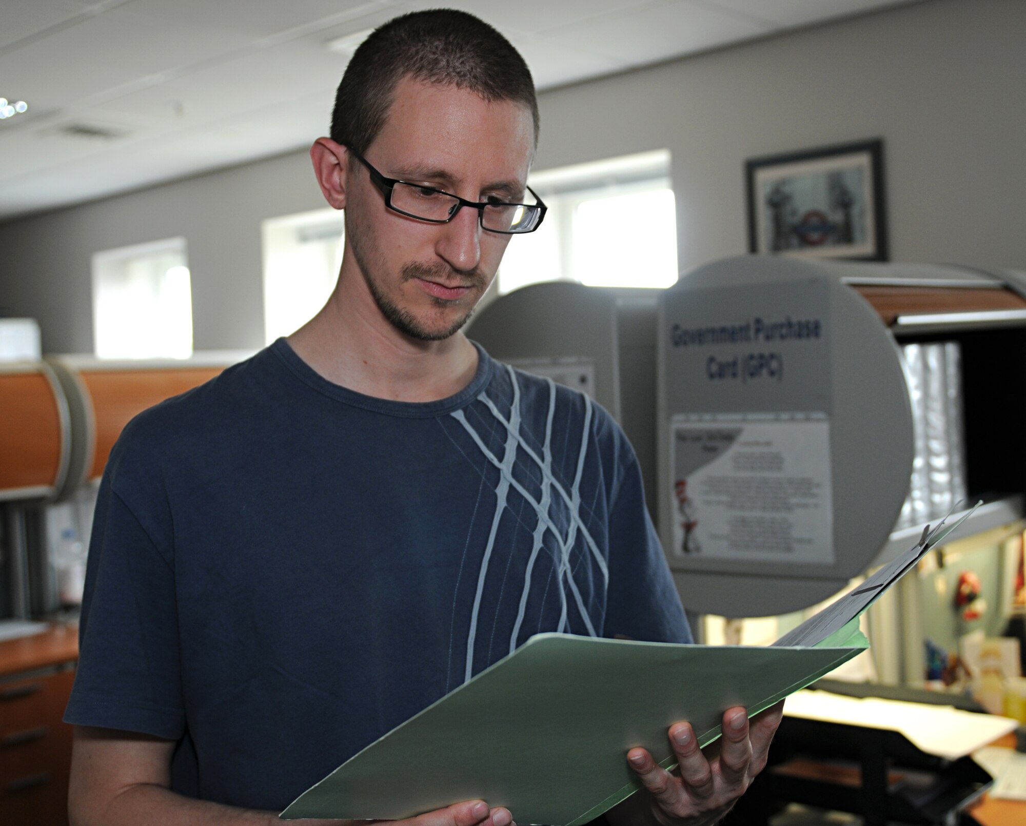 ROYAL AIR FORCE LAKENHEATH, England - Mr. Damian Owner, 48th Contracting Squadron assistant government purchase card program coordinator, checks paperwork, Sept. 20, 2011. Owner was nominated for a Liberty Spotlight because he displays the core value of "Excellence in All We Do". (U.S. Air Force photo by Airman Cory Payne) 
