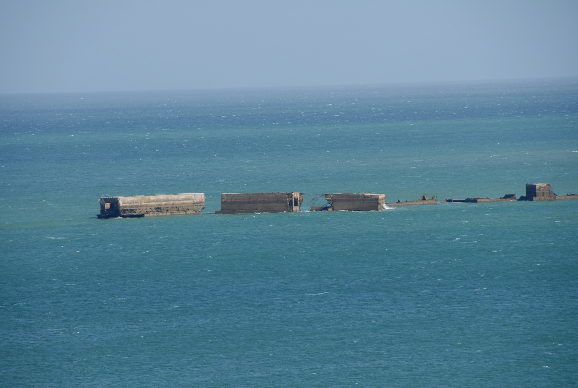 ARROMANCHES-LES-BAINS, France -- The artificial Mulberry harbor, comprised of huge concrete blocks, make a ring in the beautiful blue-green water. This harbor was used to off-load supplies for the allies during the D-Day invasion. (U.S. Air Force photo/Senior Master Sgt. Valerie J. Weaver)