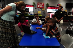 Jennifer Marsh explains Tudor.com to children from the Joint Base Charleston Youth Center, September 21, 2011, Joint Base Charleston Air Base, S.C. Tudor.com is an online tutoring program designed to help students who are struggling with school in any subject. Marsh is a Tudor.com trainer. (U.S. Air Force photo/Staff Sgt. Nicole Mickle) 
